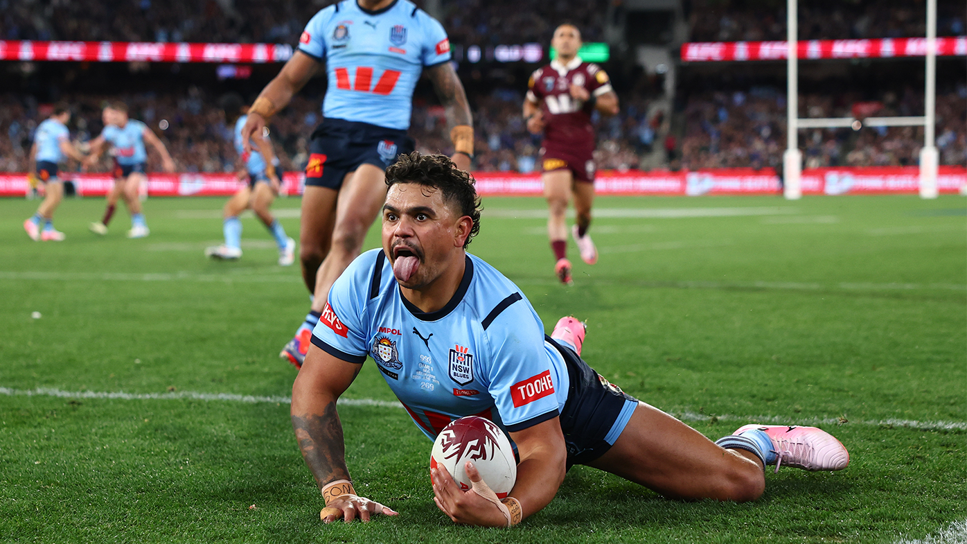 Latrell Mitchell of the Blues celebrates scoring a try.