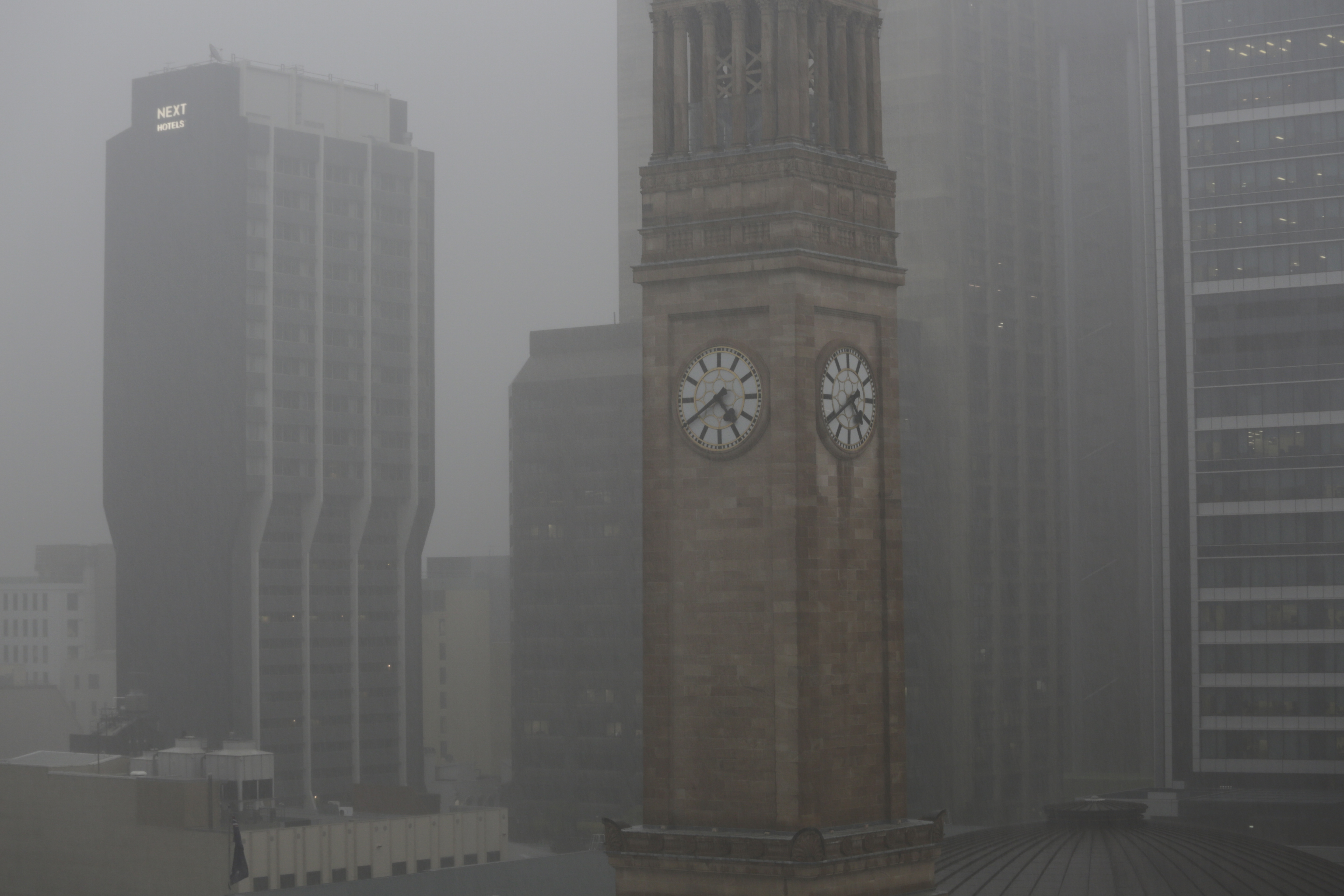 eavy rain hits Brisbane CBD as storms sweep across south-east Queensland. 