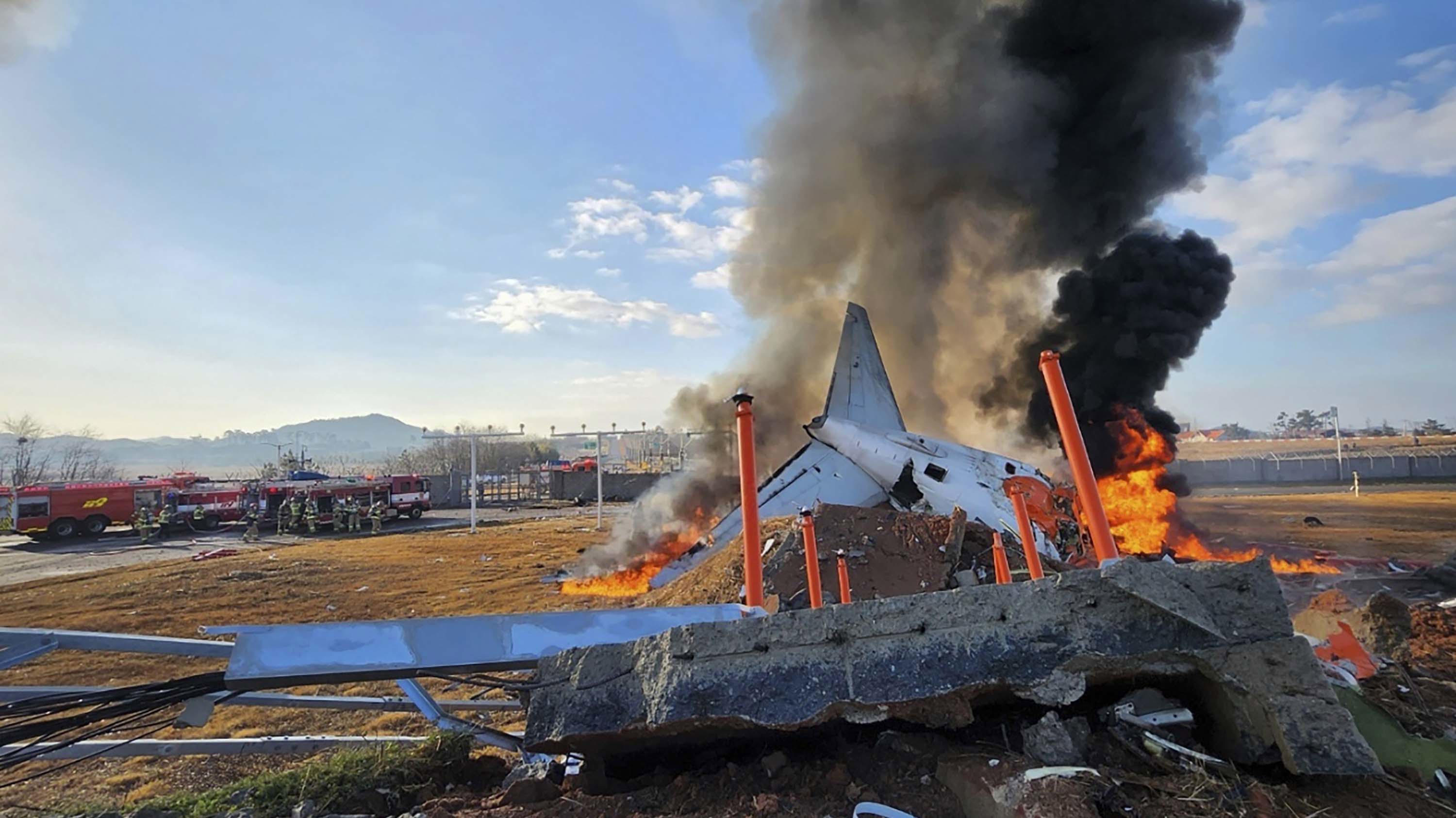  In this handout photo provided by the South Korean National Fire Agency, Jeju Air Flight 7C2216 burns after skidding off the runway at Muan International Airport on December 29, 2024 in Muan-gun, South Korea. 