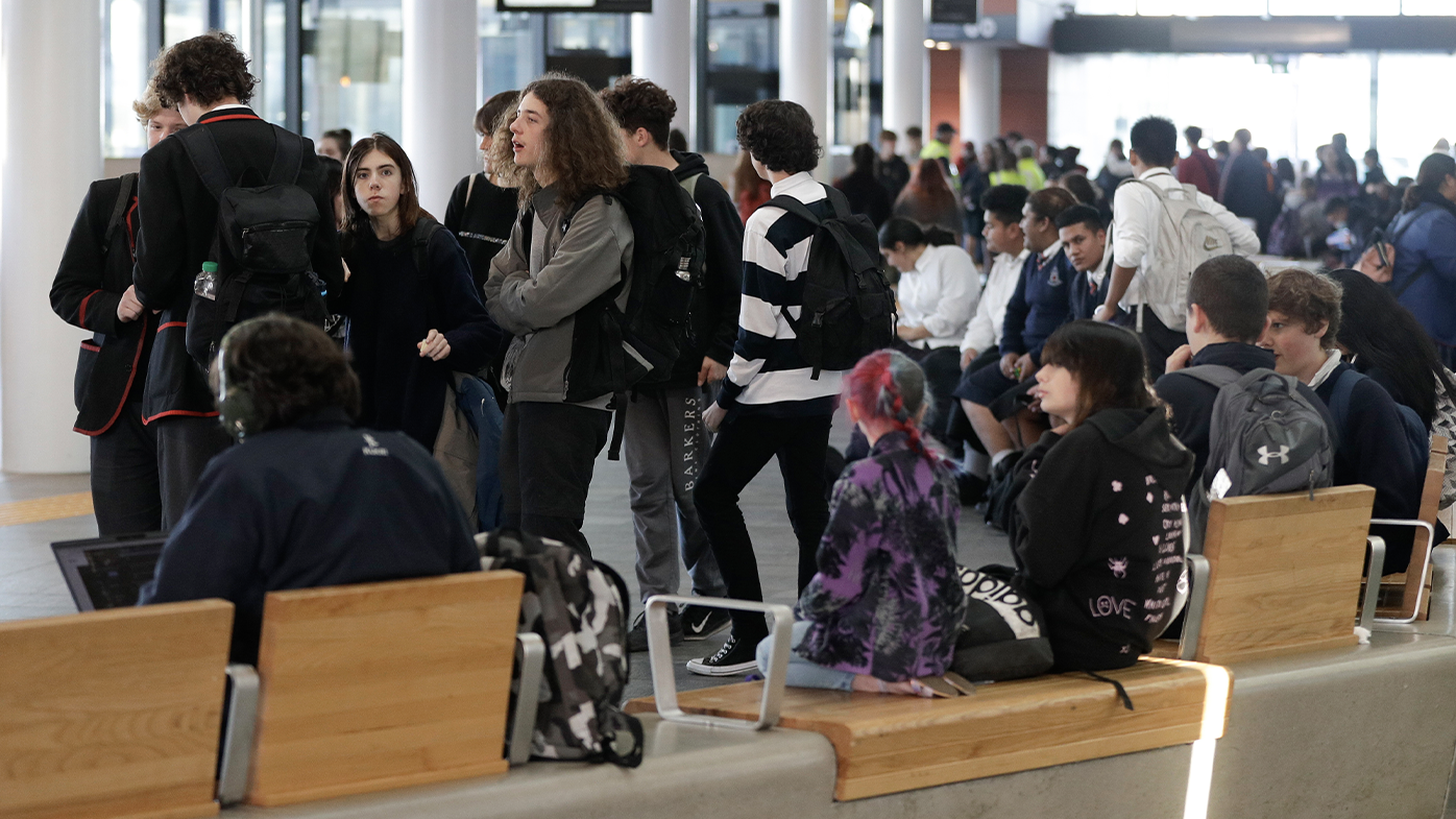 Commuters wait for transport at a bus interchange in Christchurch, New Zealand, Monday, June 8, 2020. (AP Photo/Mark Baker)