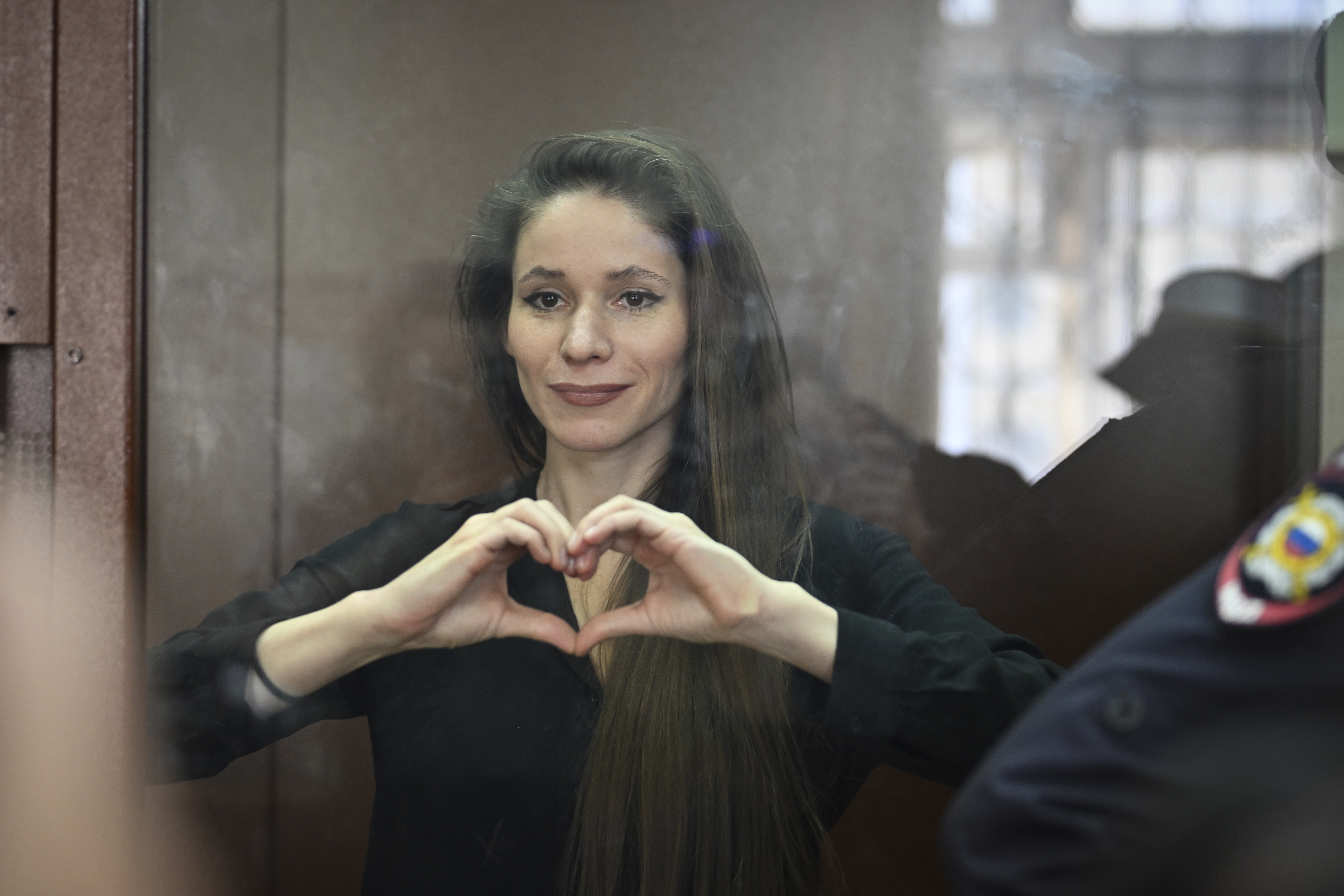 Antonina Favorskaya stands in a glass cage in a courtroom in the Basmanny District Court in Moscow, Russia, Friday, March 29, 2024.