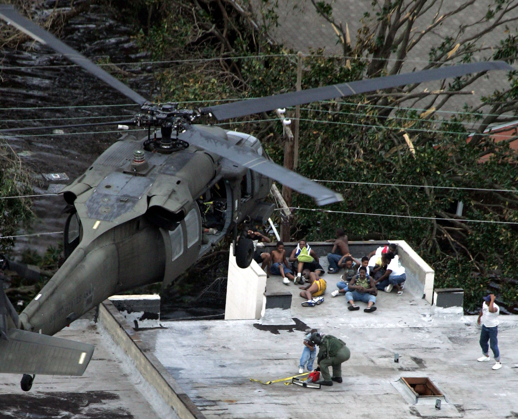 FILE - In this Sept. 1, 2005 file photo, Residents are rescued by helicopter from the floodwaters of Hurricane Katrina in New Orleans. Hurricane Ida looks an awful lot like Hurricane Katrina, bearing down on the same part of Louisiana on the same calendar date. But hurricane experts say there are differences in the two storms 16 years apart that may prove key and may make Ida nastier in some ways but less dangerous in others.(AP Photo/David J. Phillip, Pool, File)