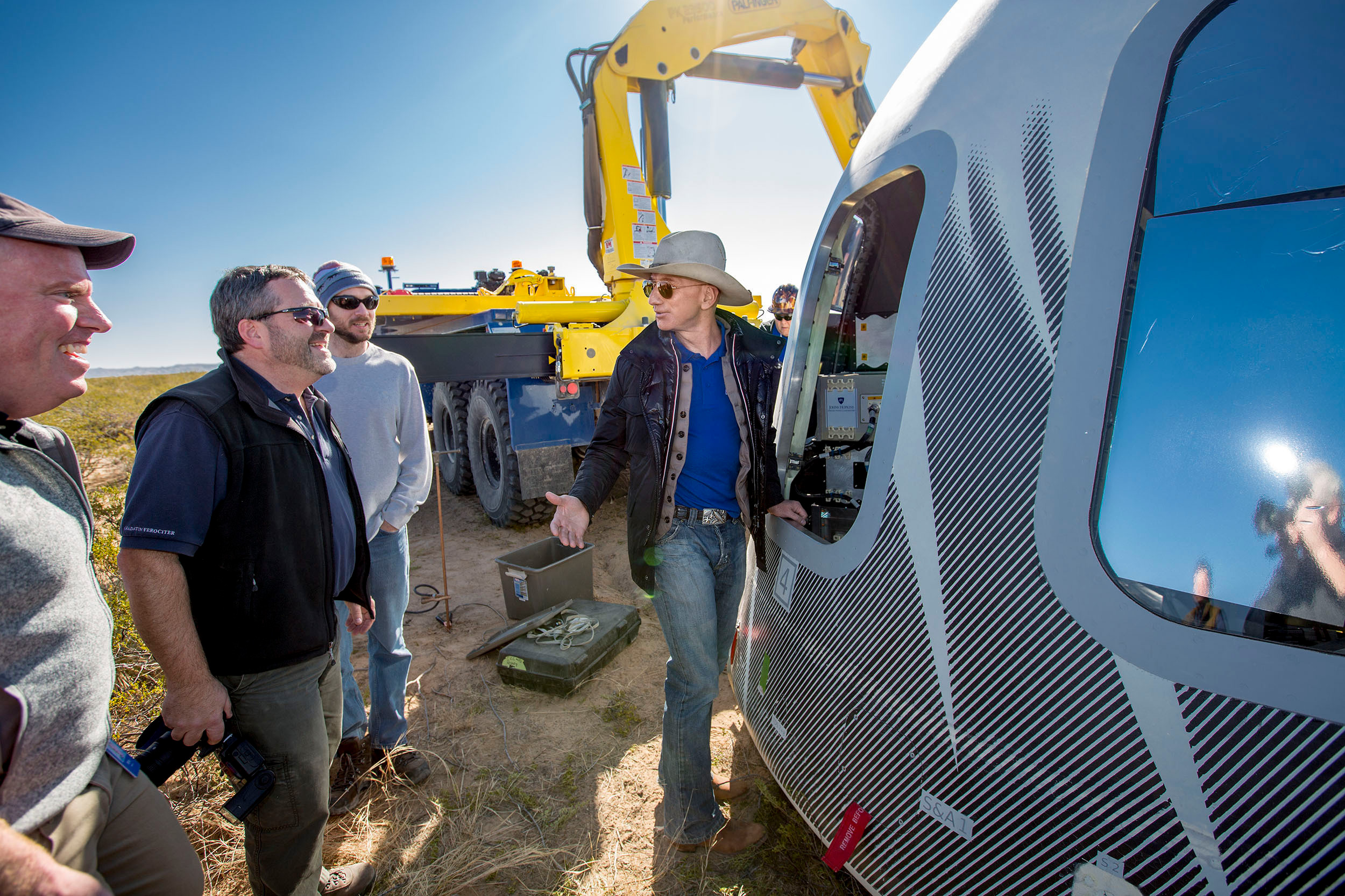 Jeff Bezos, centre, and others inspect Crew Capsule 2.0 after a test flight touchdown in West Texas. 