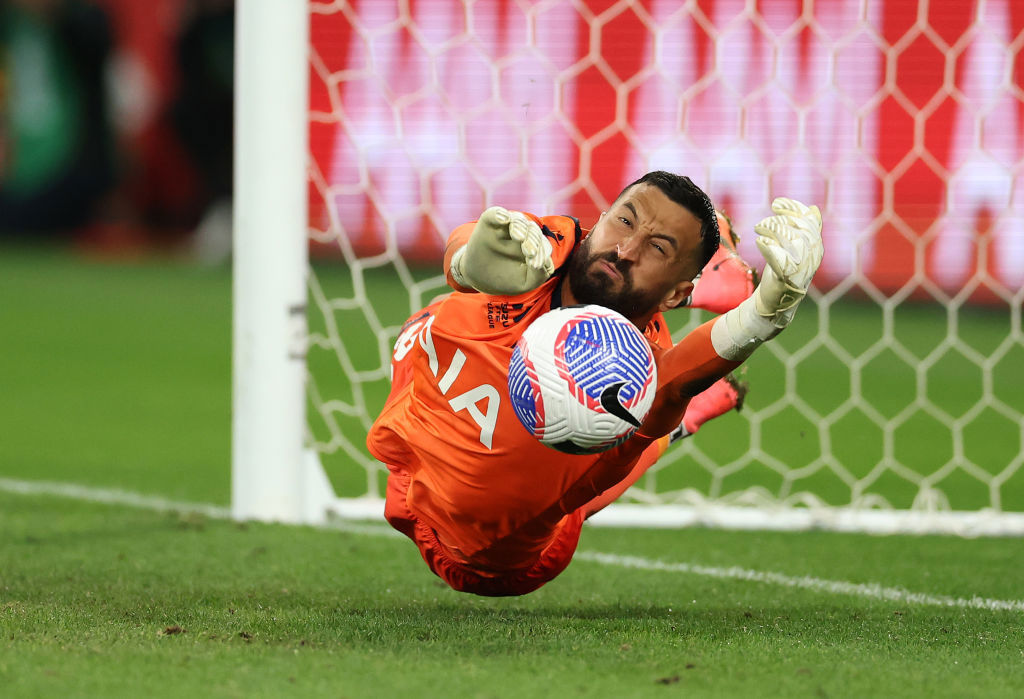 Victory goalkeeper Paul Izzo saves a penalty.