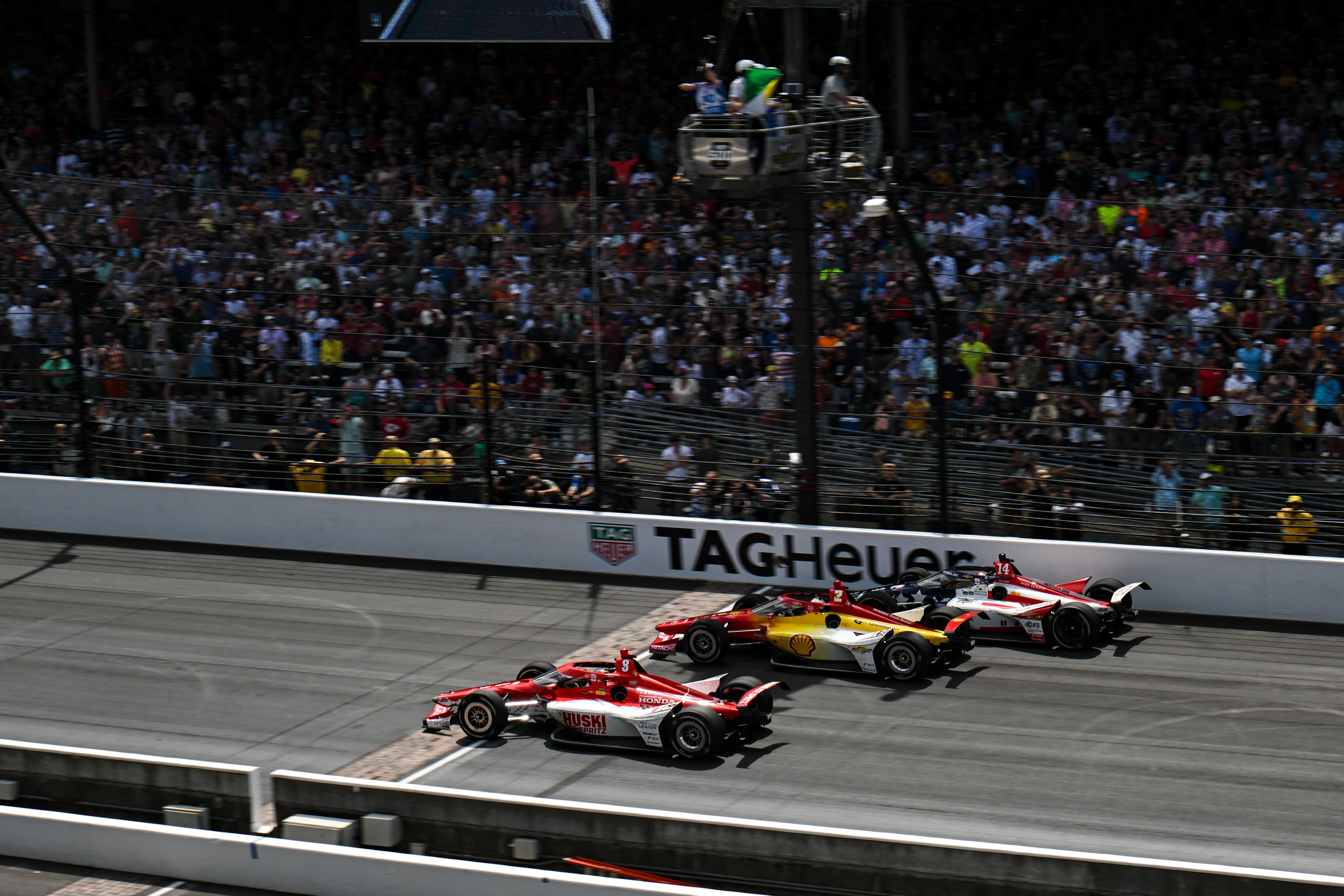 Marcus Ericsson leads Josef Newgarden and Santino Ferrucci across the line on the final restart of the 107th Indianapolis 500. 