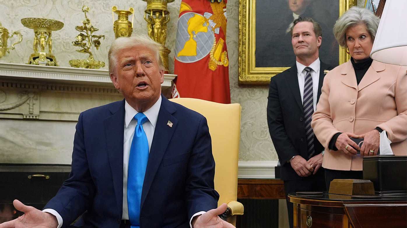 Donald Trump talks in the White House while his chief-of-staff Susie Wiles looks on.