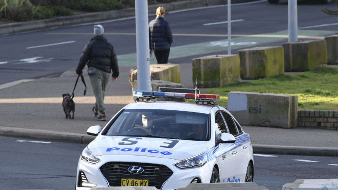 SYDNEY, AUSTRALIA - JULY 11: A police car patrols along Bondi Beach on July 11, 2021 in Sydney, Australia. Lockdown restrictions have been tightened across NSW as COVID-19 cases continue to emerge in the community. Lockdown restrictions are in place across Greater Sydney, the Blue Mountains, the Central Coast and Wollongong with all residents subject to stay-at-home orders are only permitted to leave their homes for essential reasons, including purchasing essential goods, accessing or providing