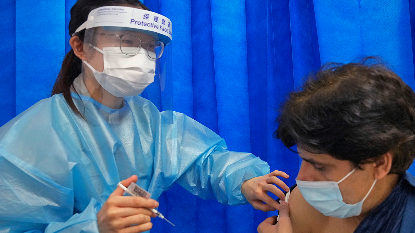 A man wearing a face mask to receive a dose of Pfizer-BioNTech COVID-19 coronavirus vaccine at a community vaccination center at the Kowloon Mosque And Islamic Centre, in Hong Kong, Saturday, March 19, 2022.