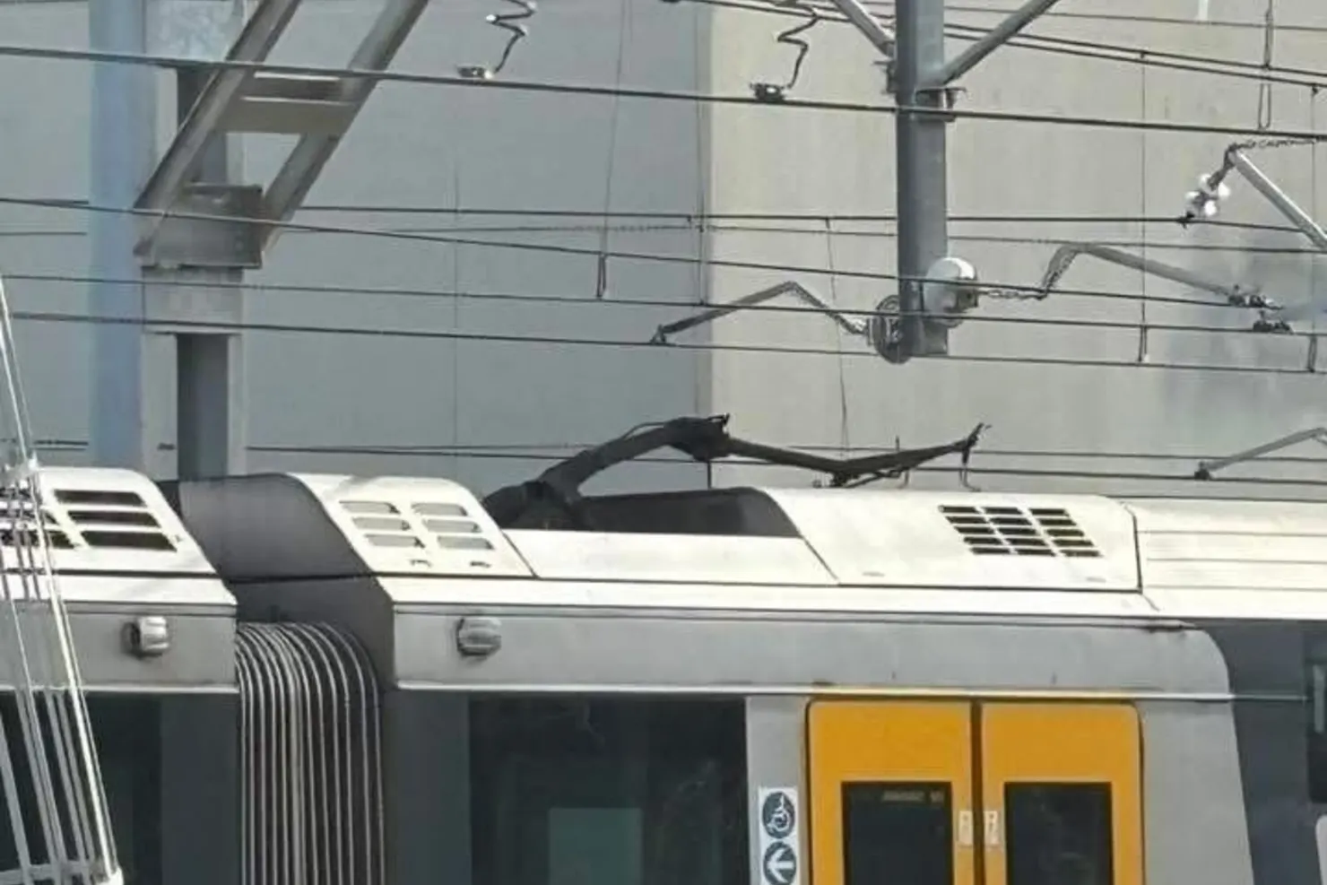 A train was stopped near Homebush after a live wire broke, landing on the roof, triggering a power outage and trapping commuters inside.Credit: