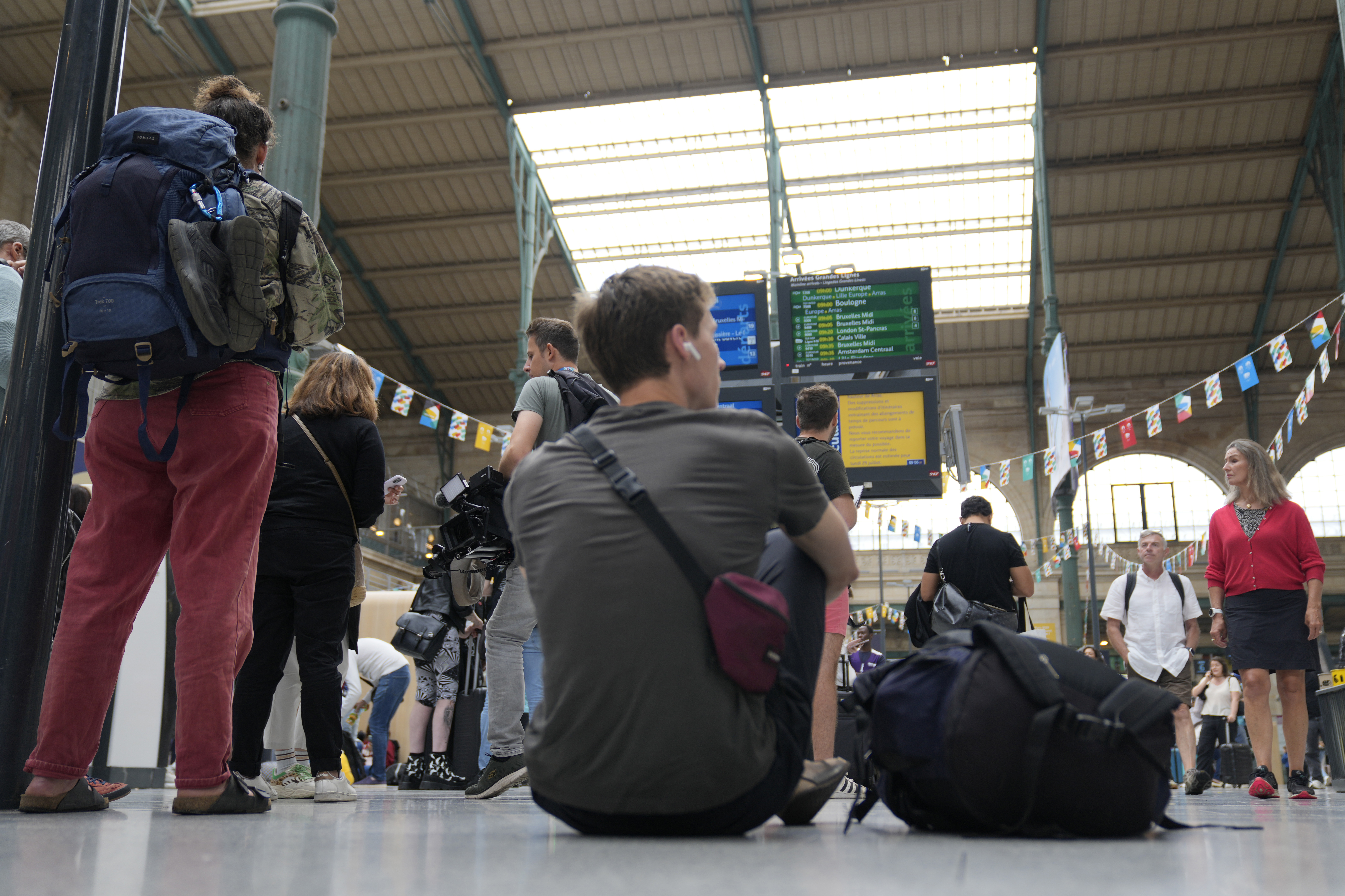 A traveller sits inside the Gare du Nord train station at the 2024 Summer Olympics, Friday, July 26, 2024, in Paris, France.