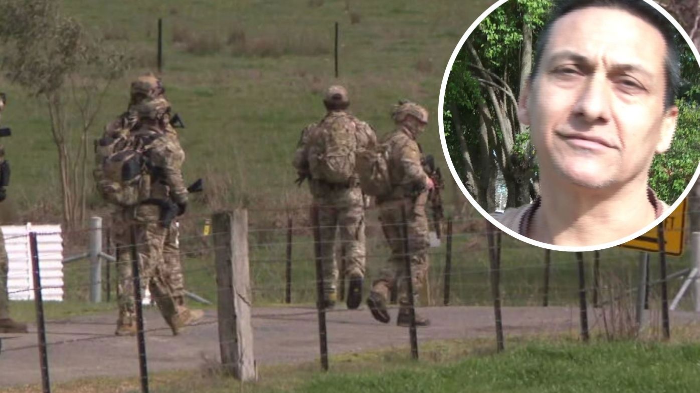 Heavily-armed police swoop on home in their hunt for accused cop killer