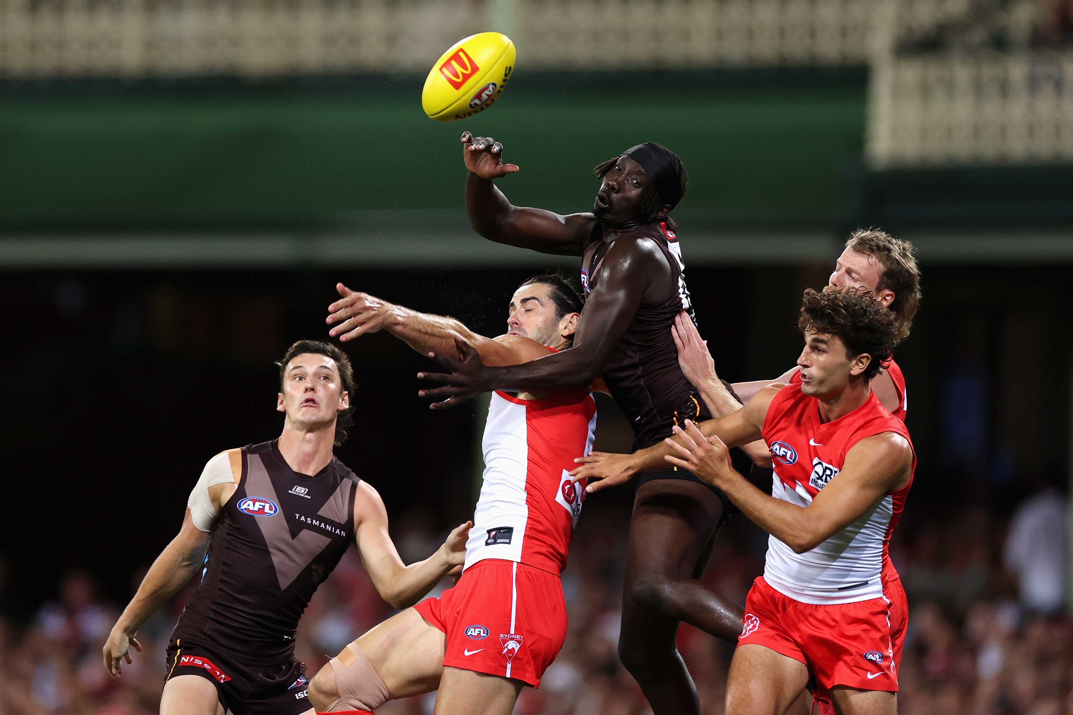 The Hawks' Mabior Chol and the Swans' Brodie Grundy contest a mark. 