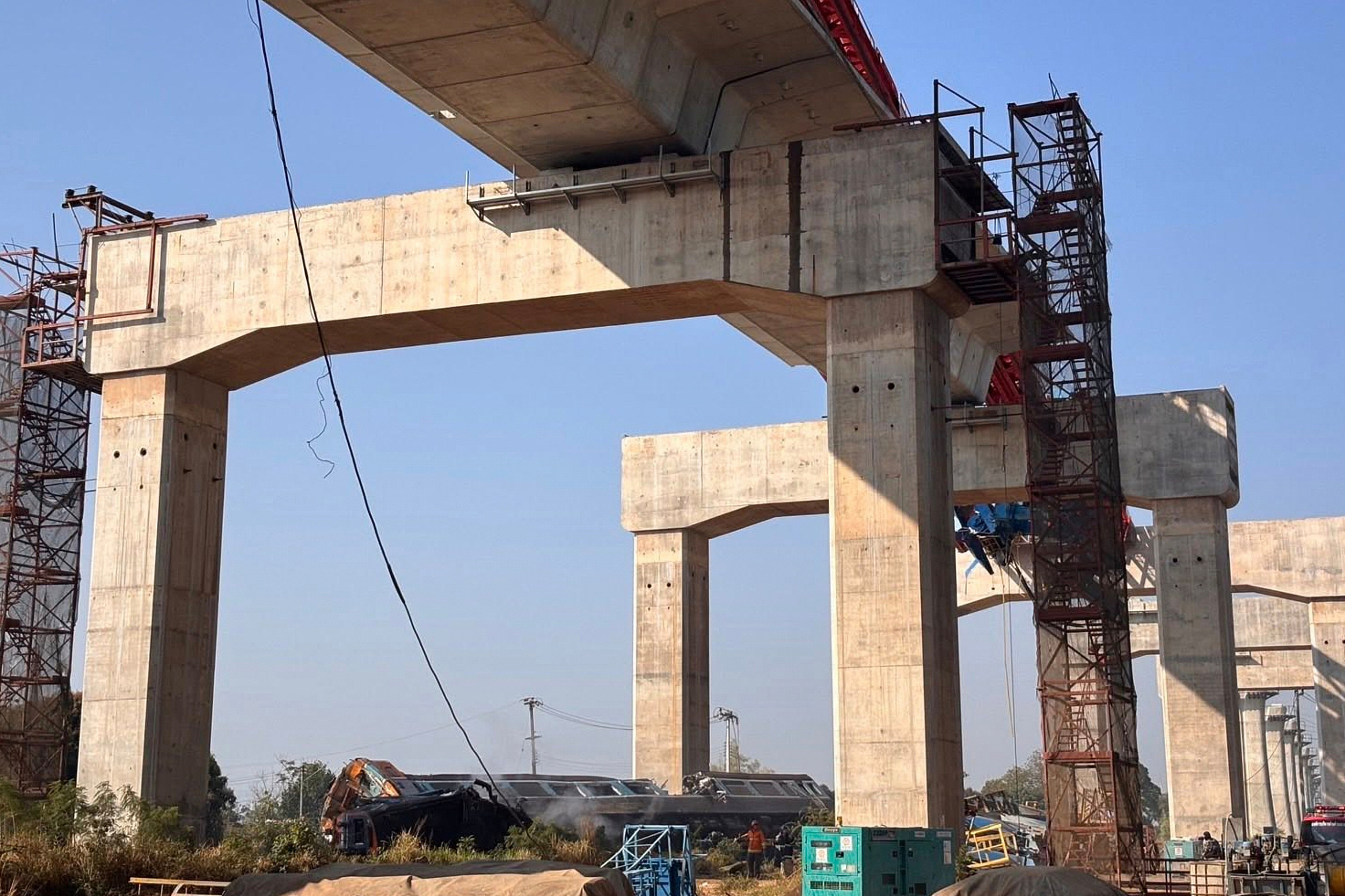 This photo provided by State Railway of Thailand shows a scene after a construction crane fell into a passenger train in Nakhon Ratchasima province, Thailand Wednesday, Jan. 14, 2026. (State Railway of Thailand via AP)
