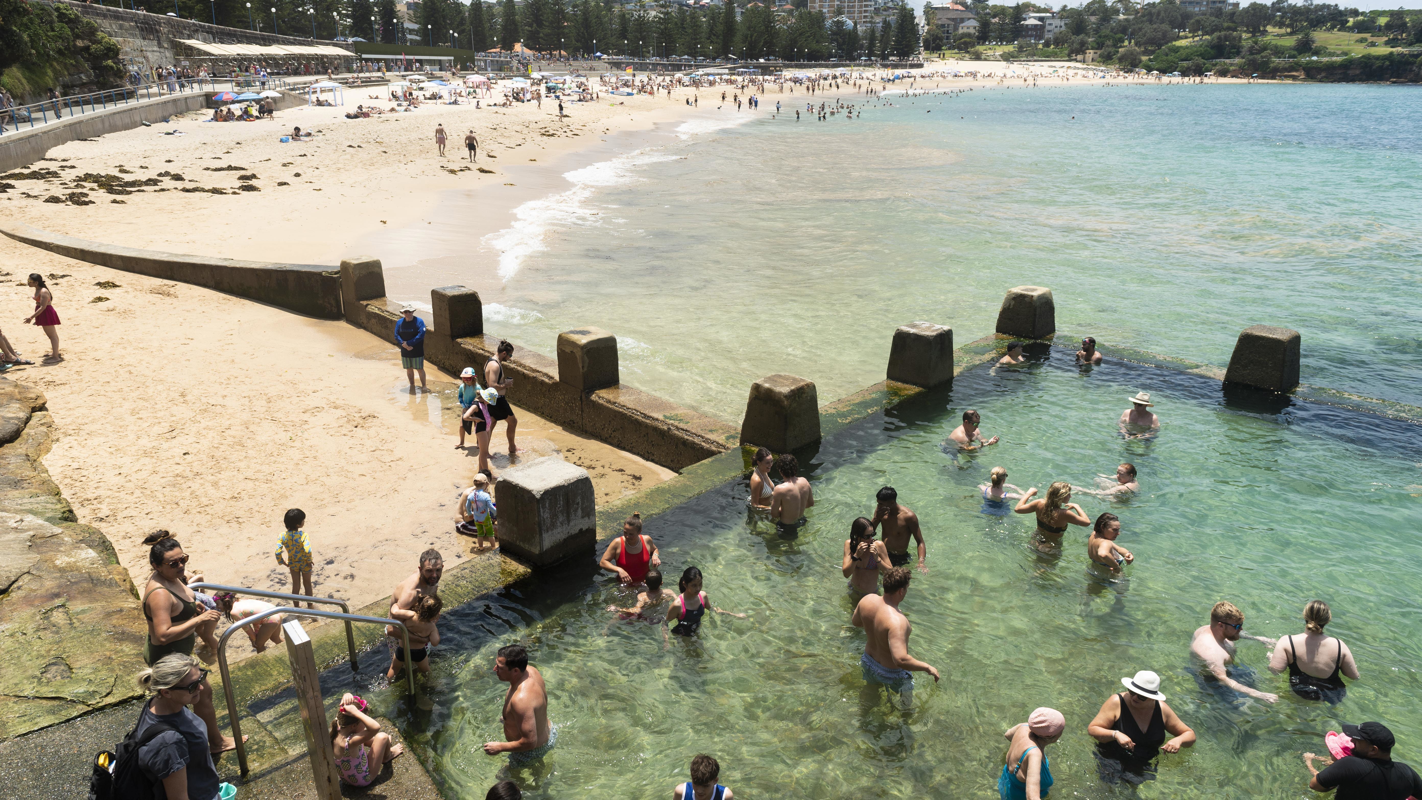People enjoy the summer weather at Coogee beach.