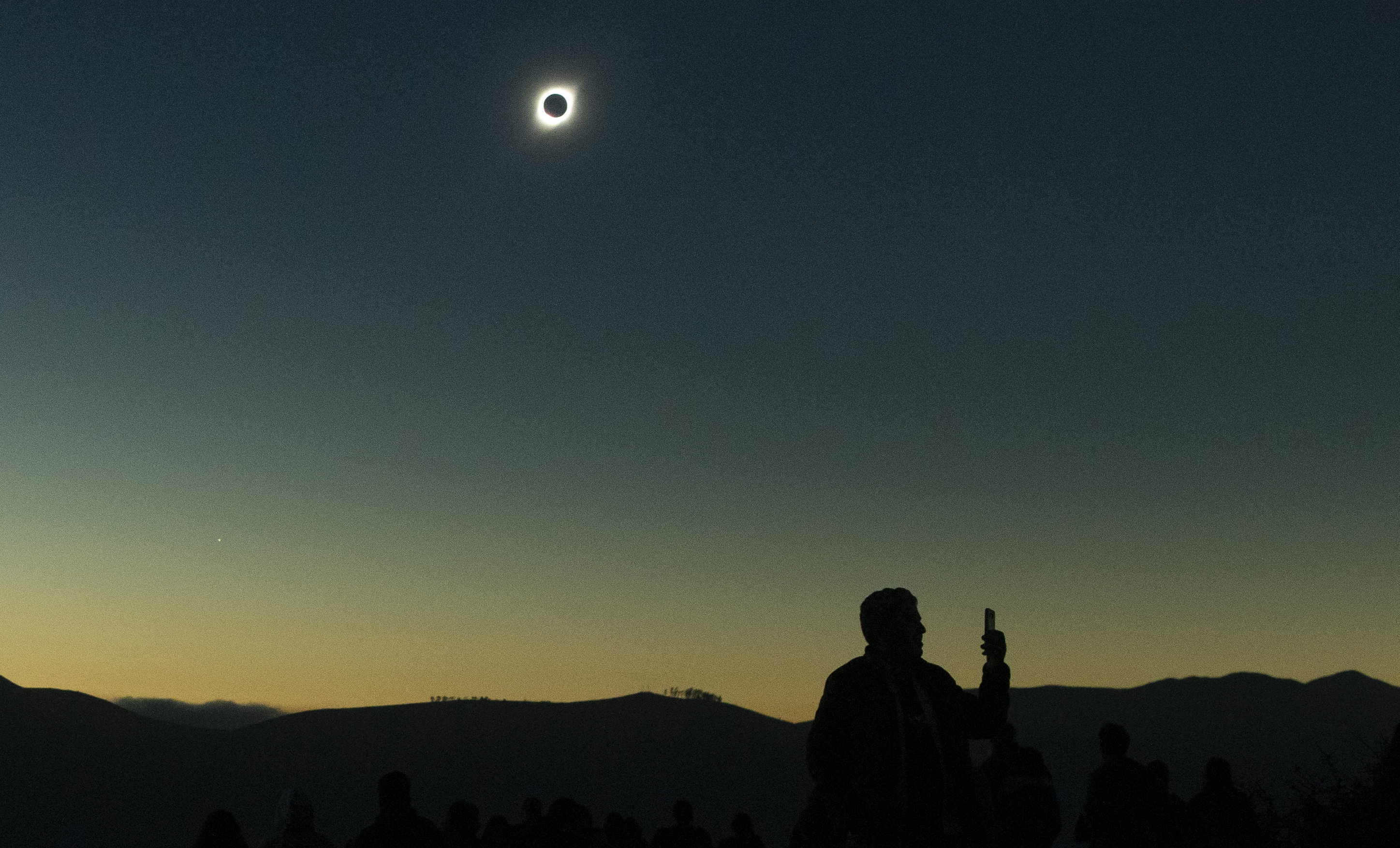 Sun completely eclipsed in Chilean desert.