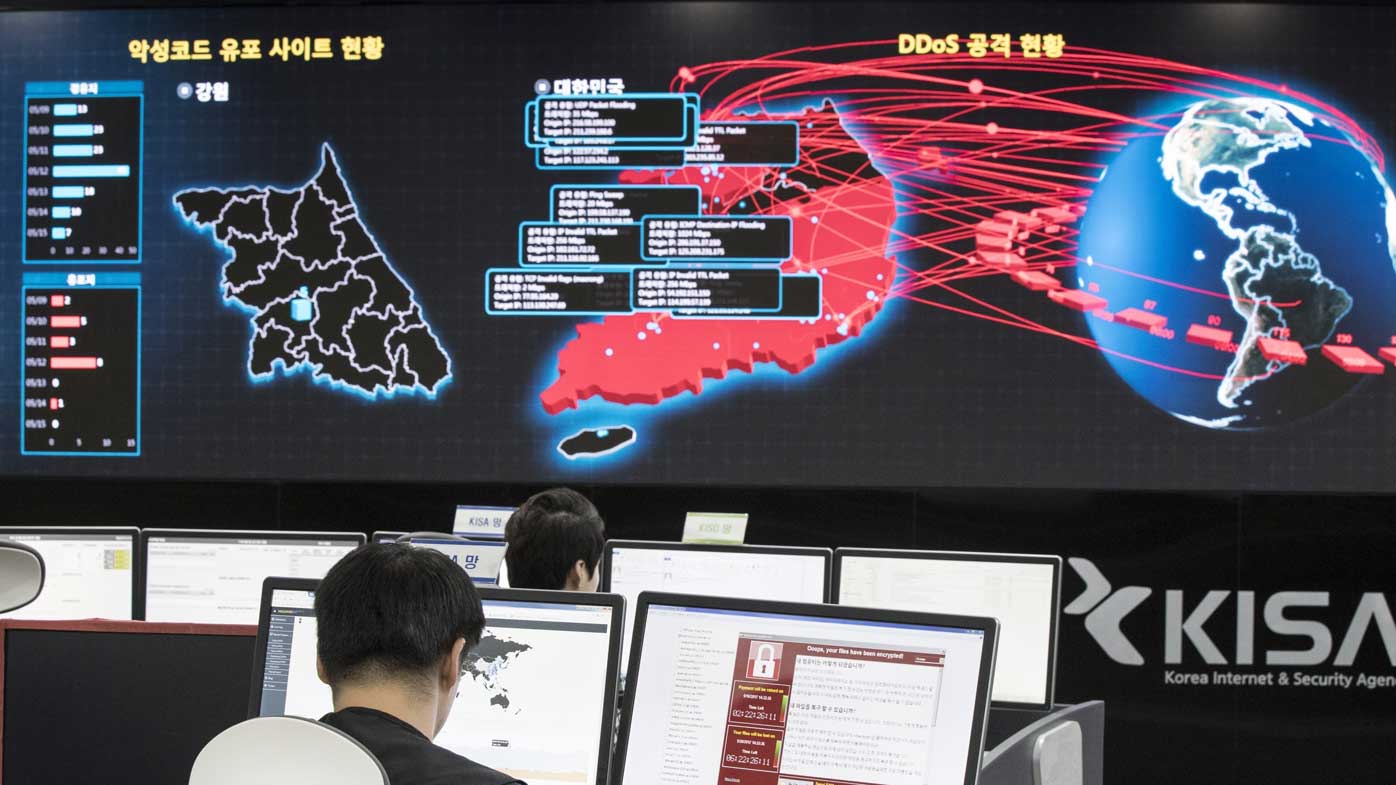 Employees watch electronic boards to monitor possible ransomware cyberattacks at the Korea Internet and Security Agency in Seoul, South Korea.