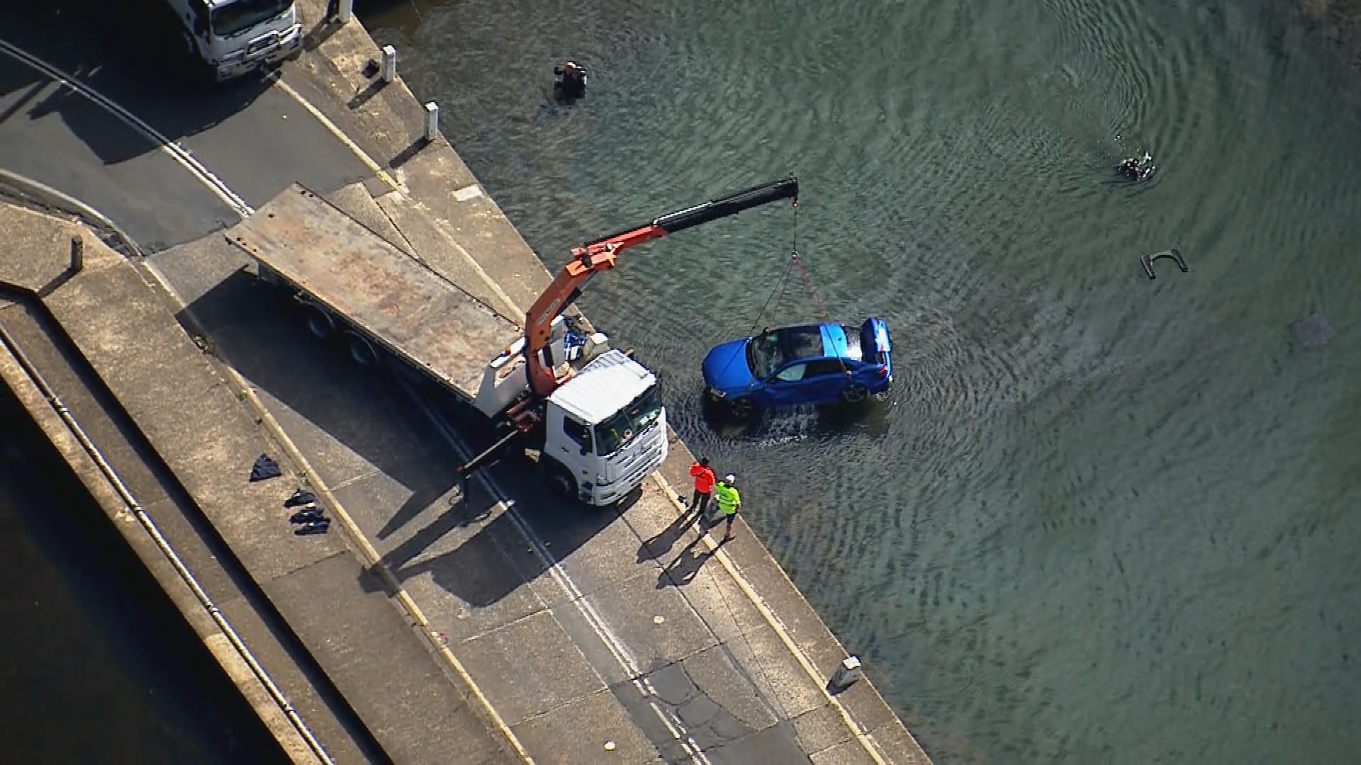 Car being pulled from the water. 