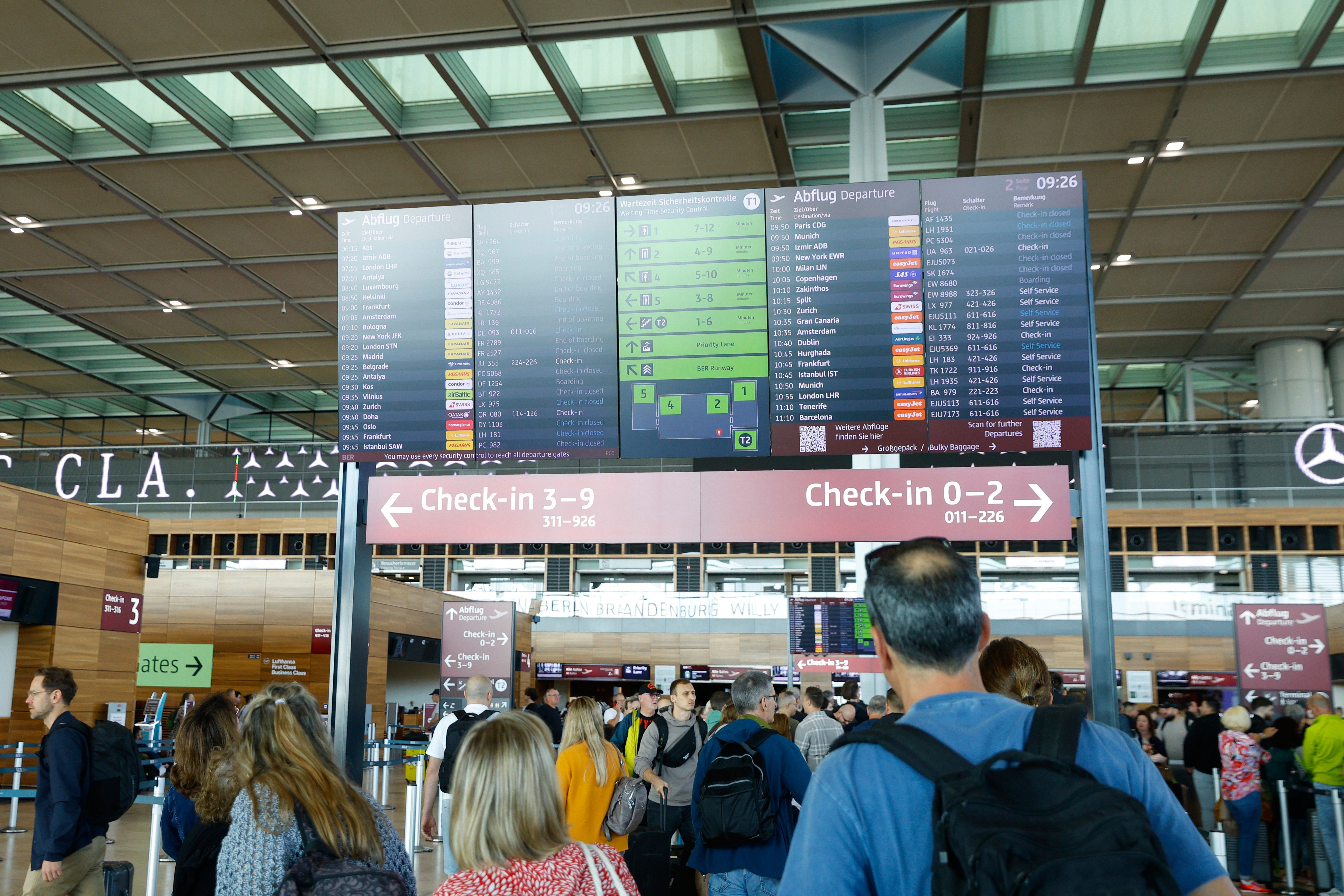 People at BER airport as a cyber attack has caused delays, in Berlin, Germany, Saturday, Sept. 20, 2025. (Carsten Koall/dpa via AP)