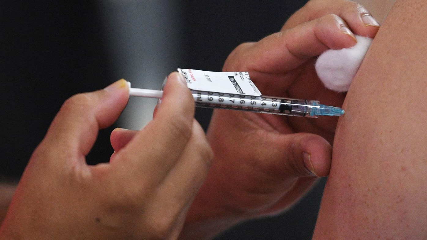 A health care worker receives their COVID-19 vaccination at the Westmead Hospital Vaccination Hub in Sydney, Monday, March 1, 2021.