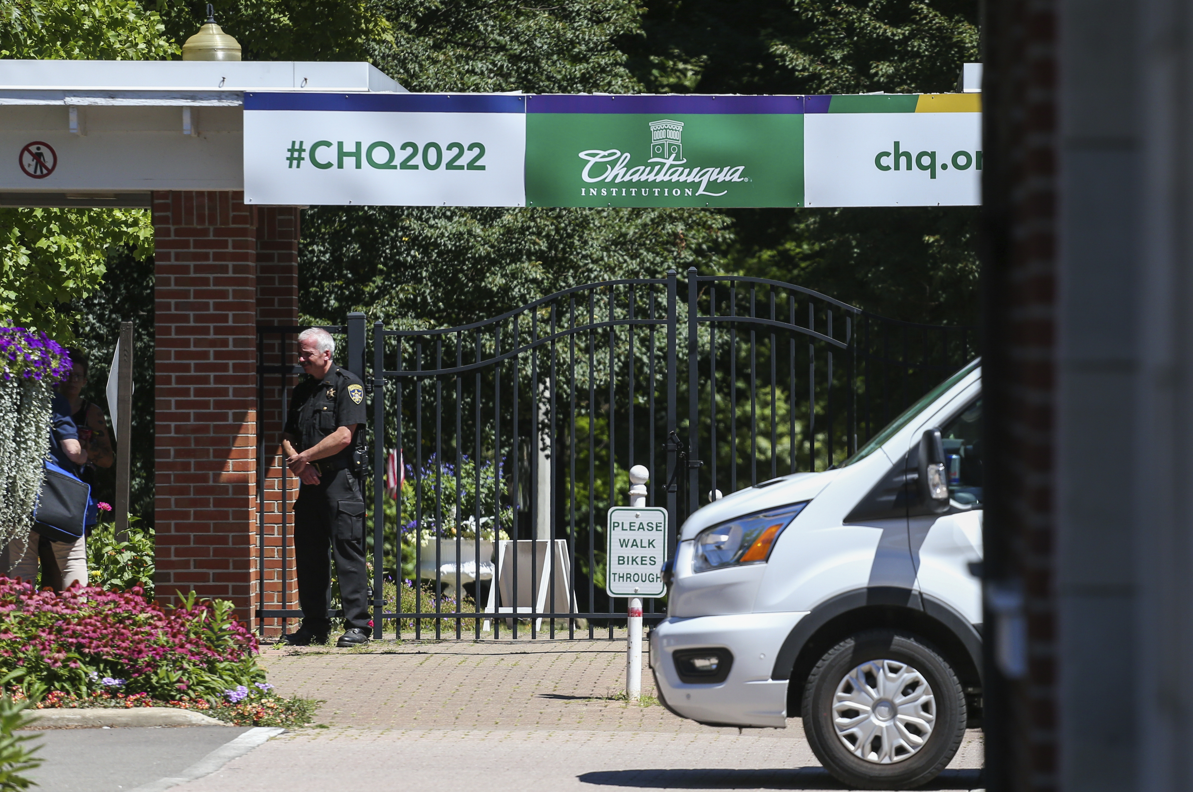 An officer stands outside a gate of the Chautauqua Institution in Chautauqua, N.Y., Friday, Aug. 12, 2022. 