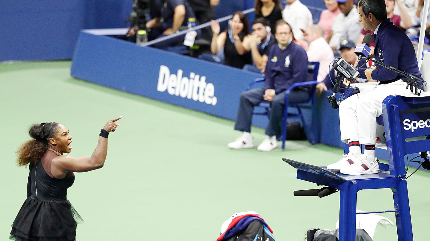 Serena Williams of the US gestures towards chair umpire Carlos Ramos (R) as she plays Naomi Osaka of Japan during the women's final