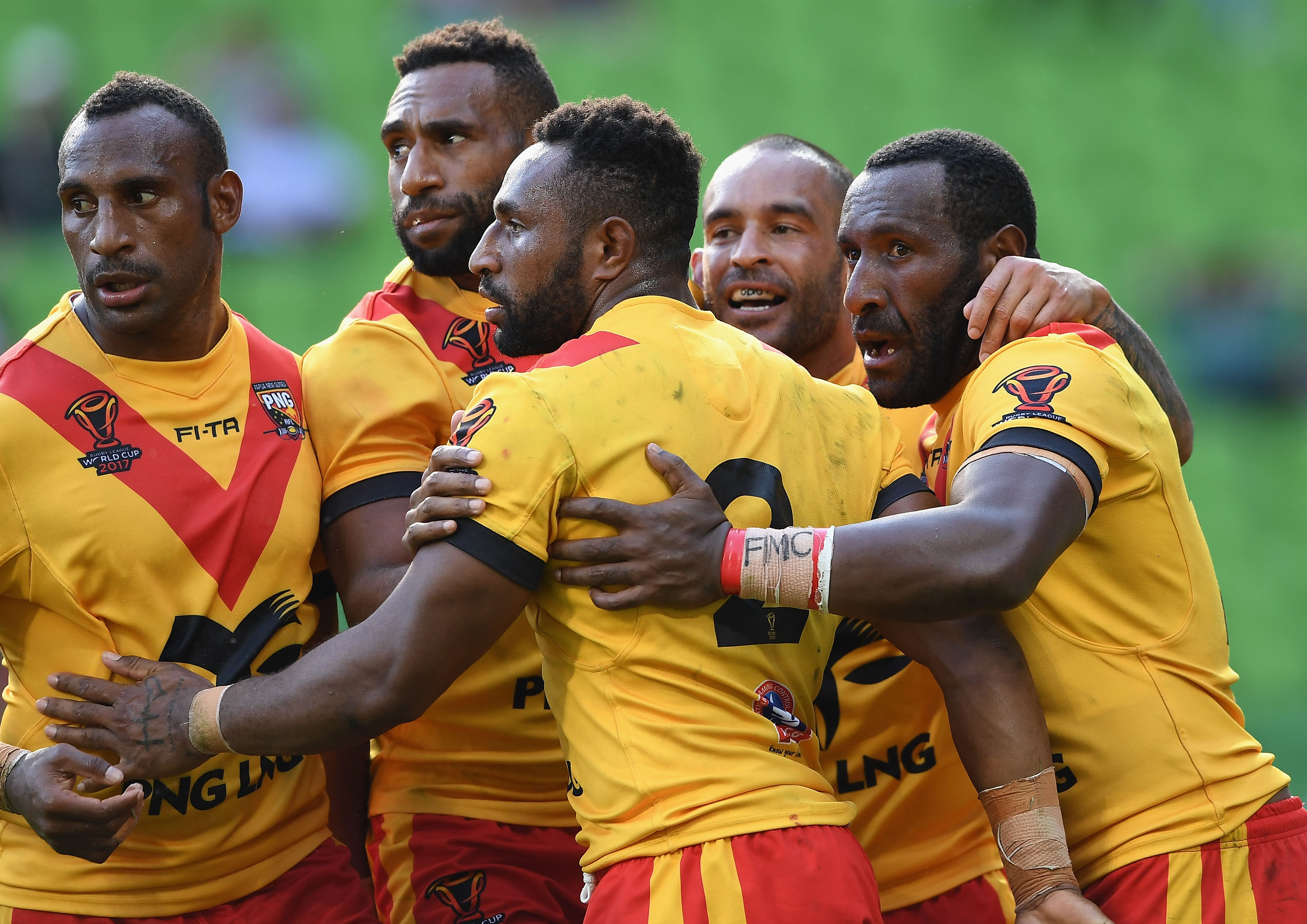 Papua New Guinea Kumuls players celebrate a try against England at the 2017 Rugby League World Cup quarter finals.