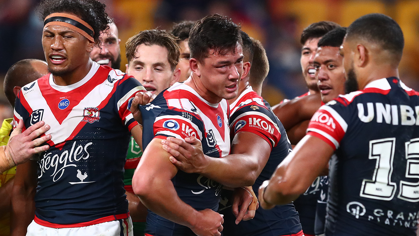 Joey Manu is pulled away by teammates after suffering a cheek injury after being hit by Latrell Mitchell.