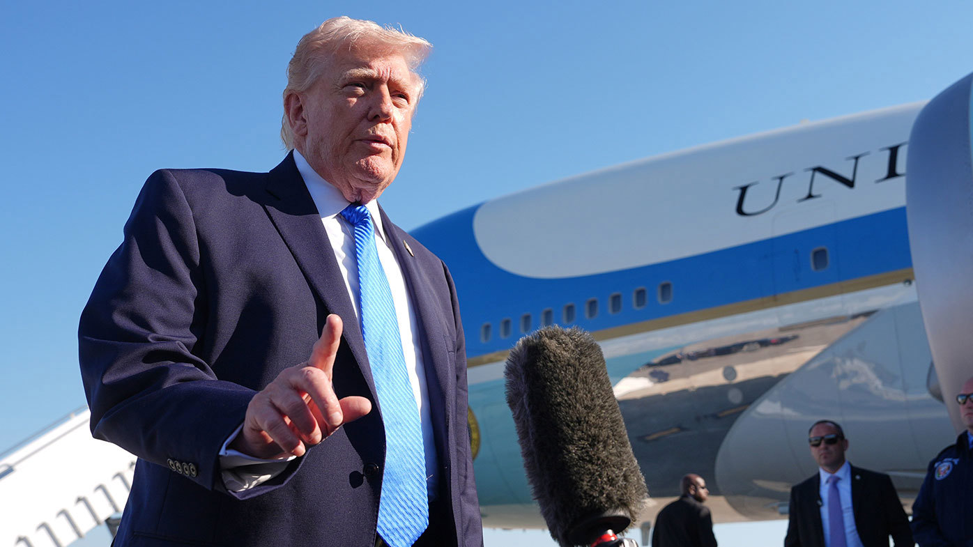 Donald Trump speaks to reporters on the tarmac at Palm Beach International Airport.