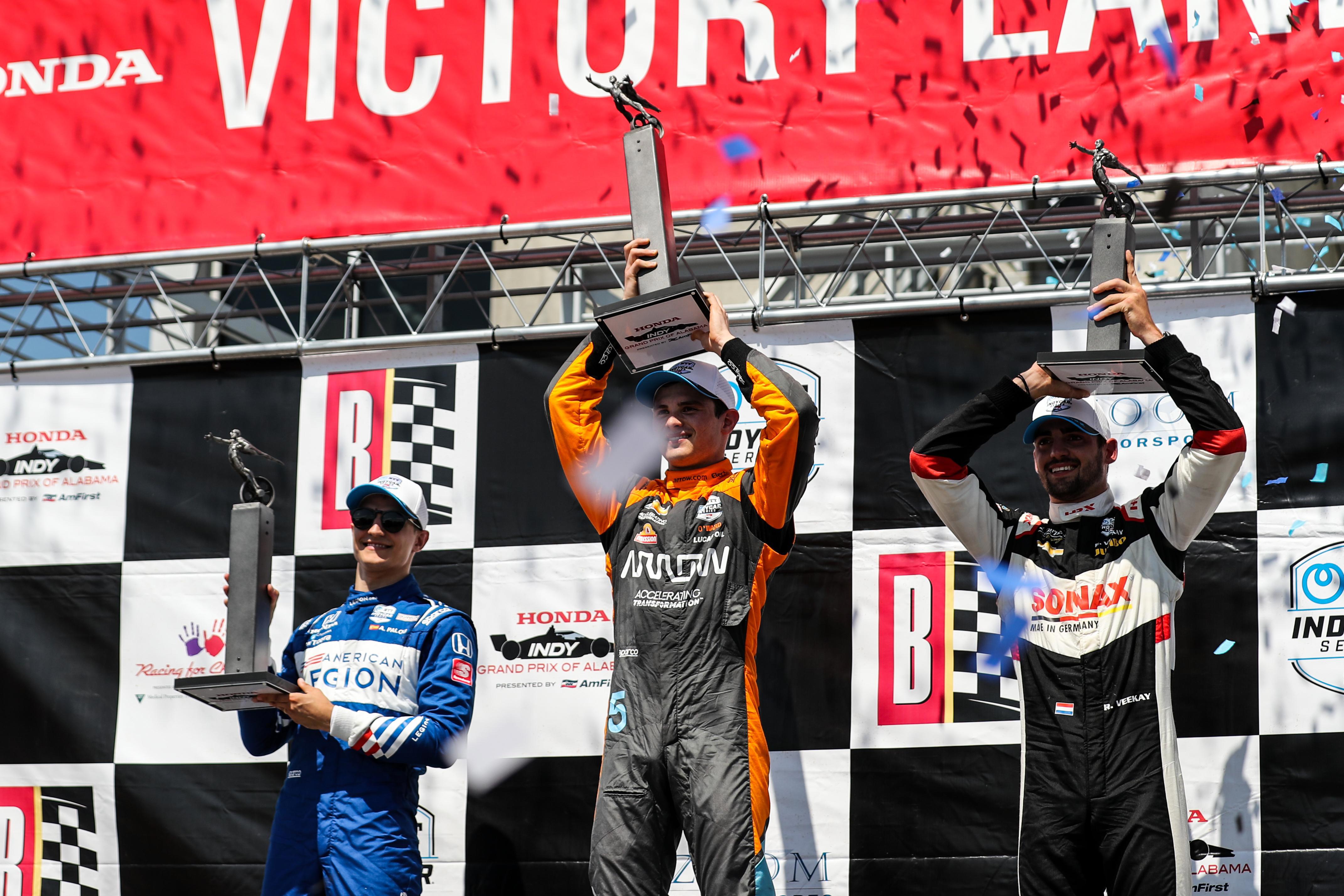 Alex Palou (from left), Pato O'Ward, and Rinus VeeKay stand on the Barber podium,