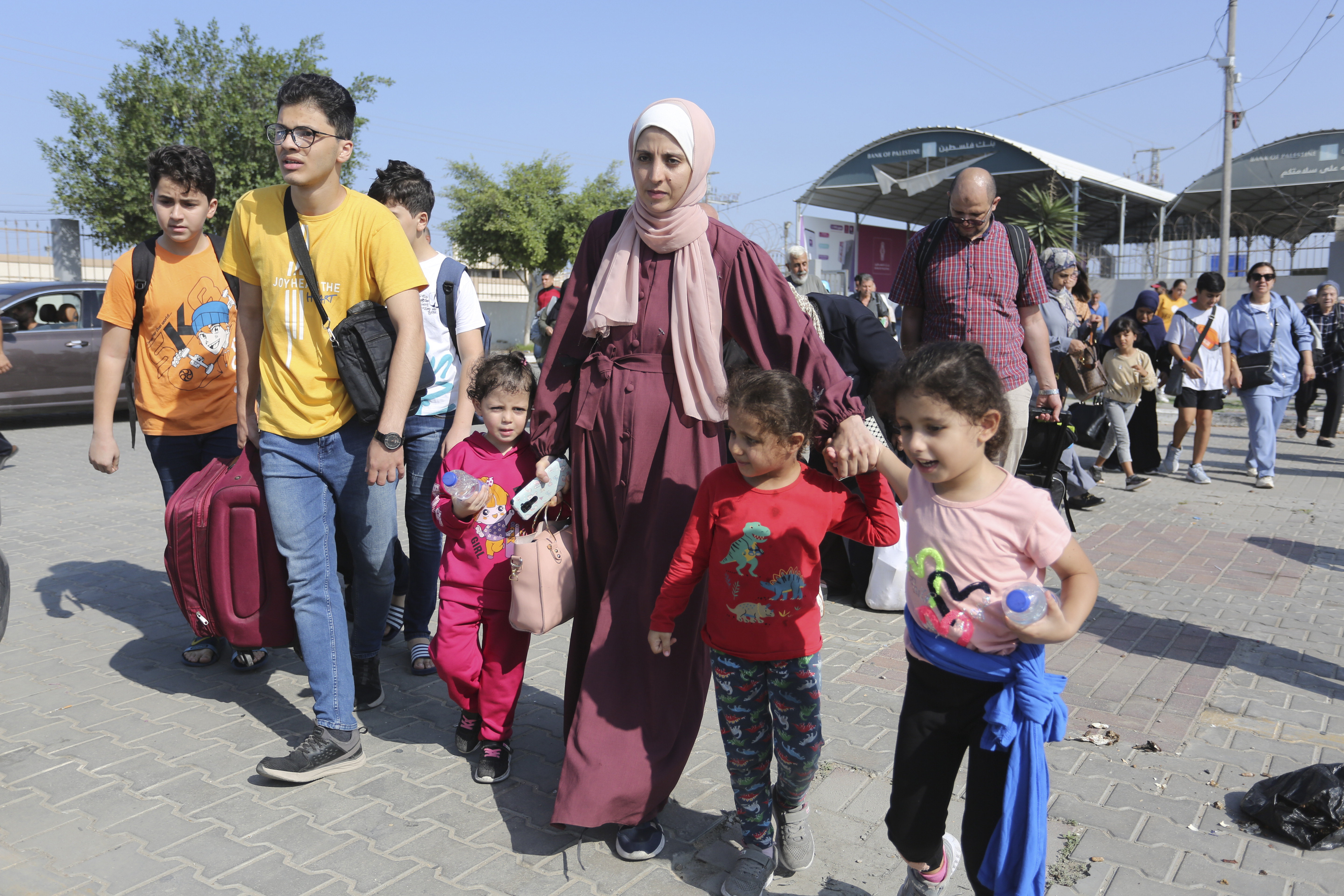 Palestinians cross to the Egyptian side of the Rafah border