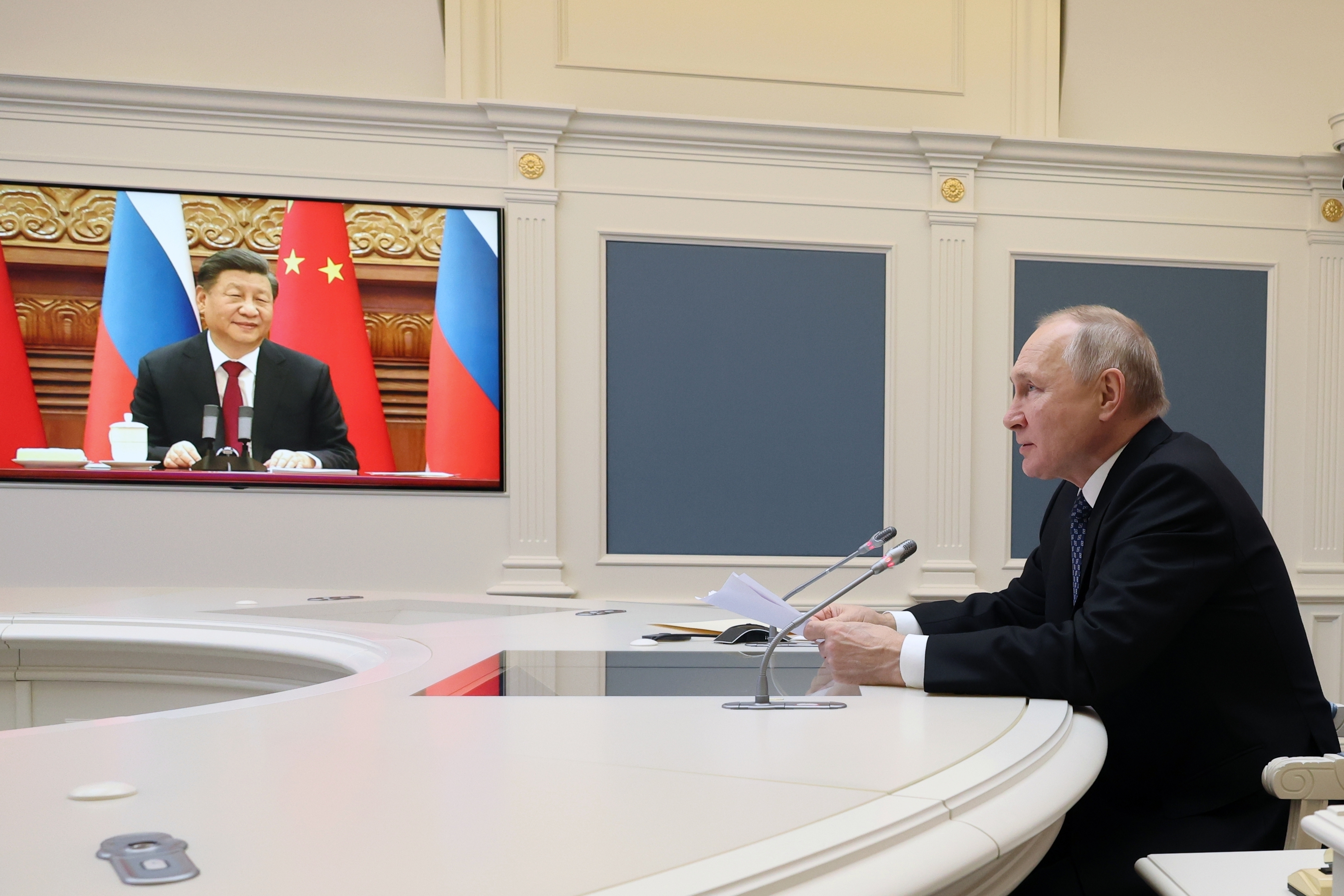 Russian President Vladimir Putin speaks during a meeting with Chinese President Xi Jinping, seen onscreen,  via  a video conference at the Kremlin in Moscow, Russia, Friday, Dec. 30, 2022 