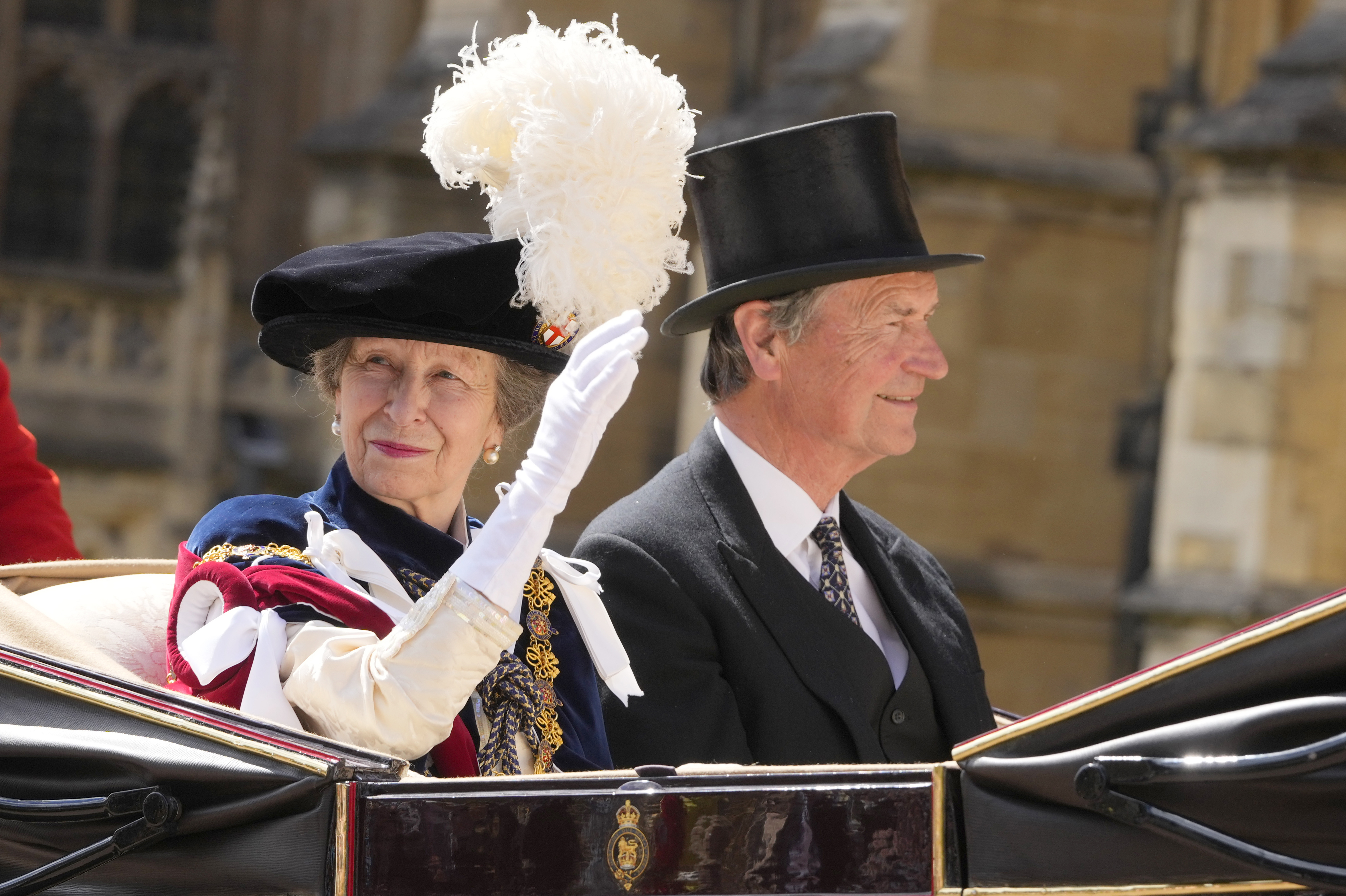 Princess Anne and her husband Tim Lawrence ride in a carriage after attending the Order of the Garter service, which is held at St George's Chapel at Windsor Castle, in Windsor, England, Monday, June 17, 2024. 