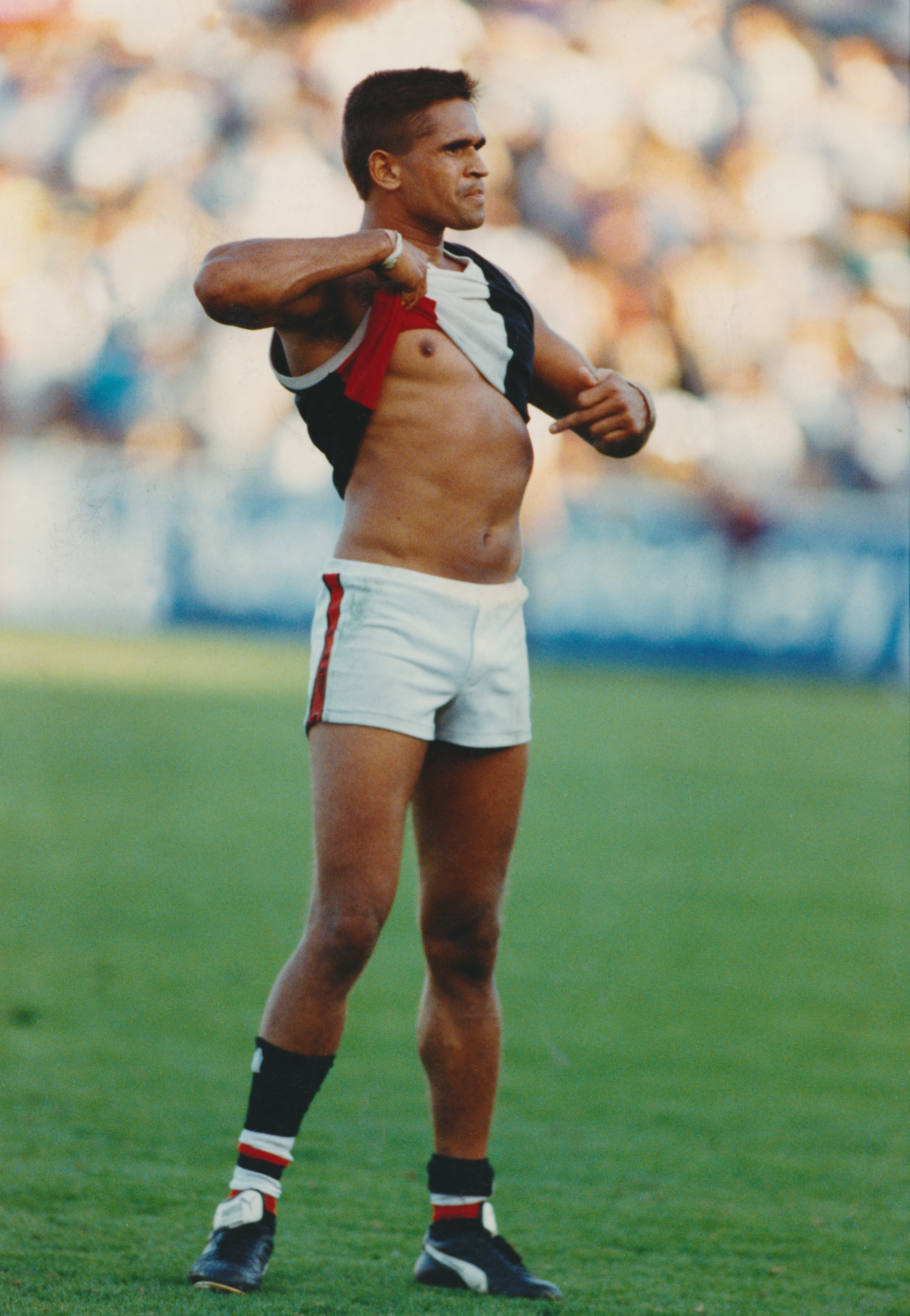 Wayne Ludbey's iconic photo of Nicky Winmar after St Kilda defeated Collingwood in 1993. Thirty years on, Collingwood have formally apologised.