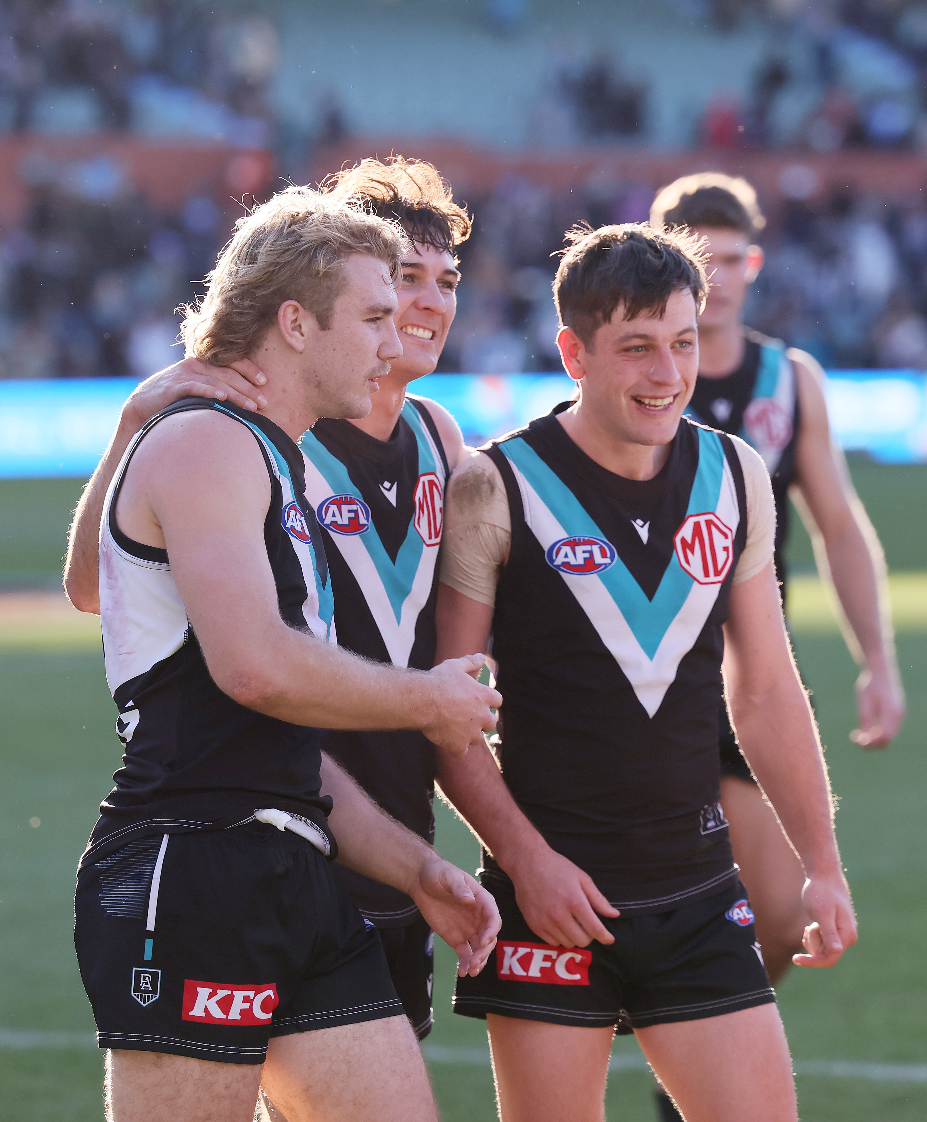 Jason Horne-Francis, Connor Rozee and Zak Butters of the Power celebrate their win over the Western Bulldogs.