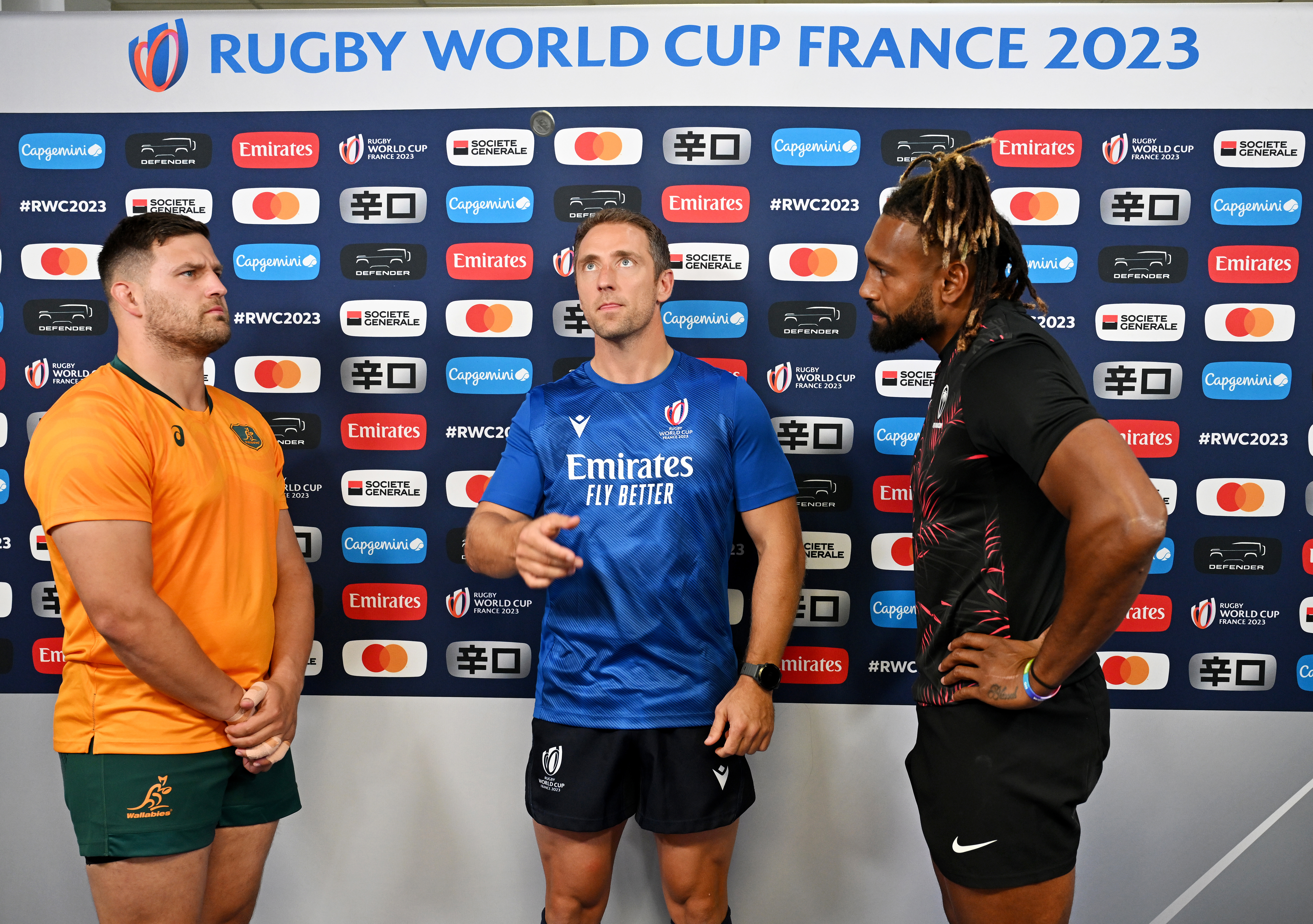 Dave Porecki of Australia and Waisea Nayacalevu of Fiji join referee Andrew Brace at the coin toss.