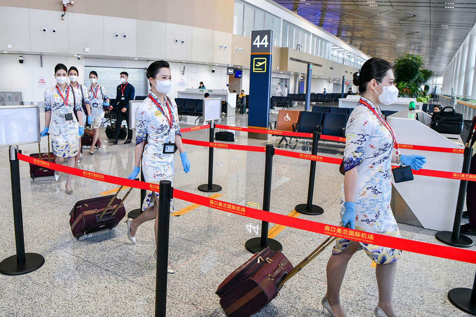 Hainan Airlines flight attendants prepare to board a plane at Haikou Meilan International Airport