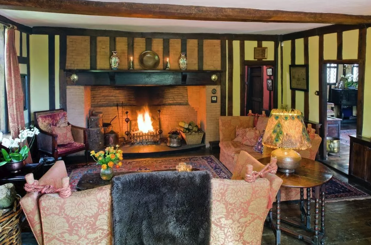 The home's drawing room with the 15th century open fireplace.