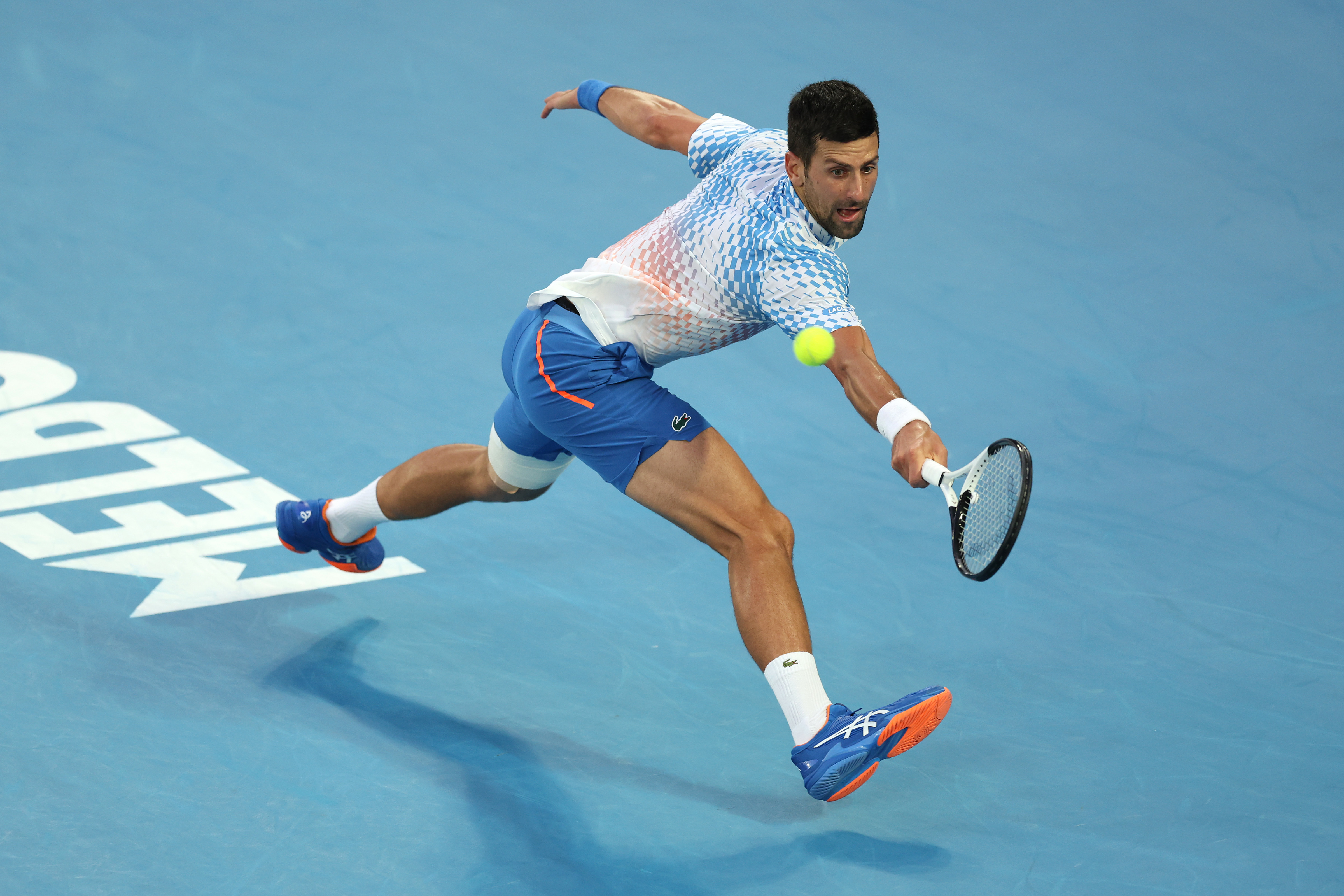 Novak Djokovic plays a backhand.