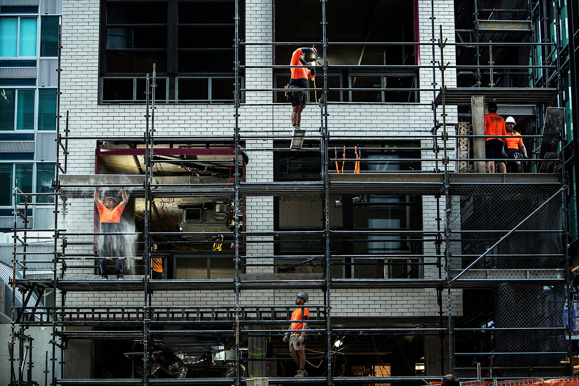 Workers are seen taking down cladding ahead of the first view of the North Sydney Metro station, in North Sydney, Friday, 31 May 2024.