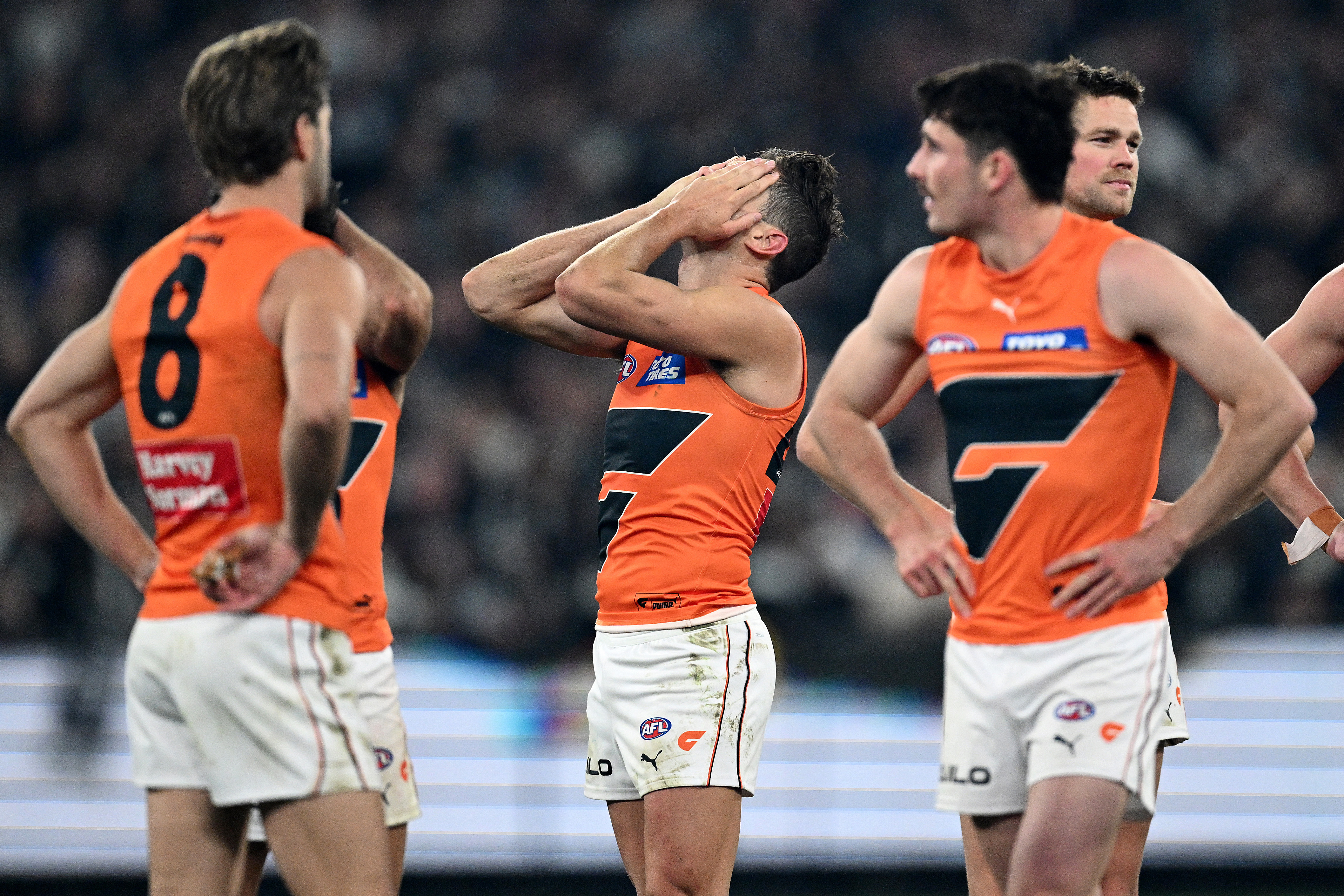 The Giants look dejected after losing their preliminary final loss to the Magpies.