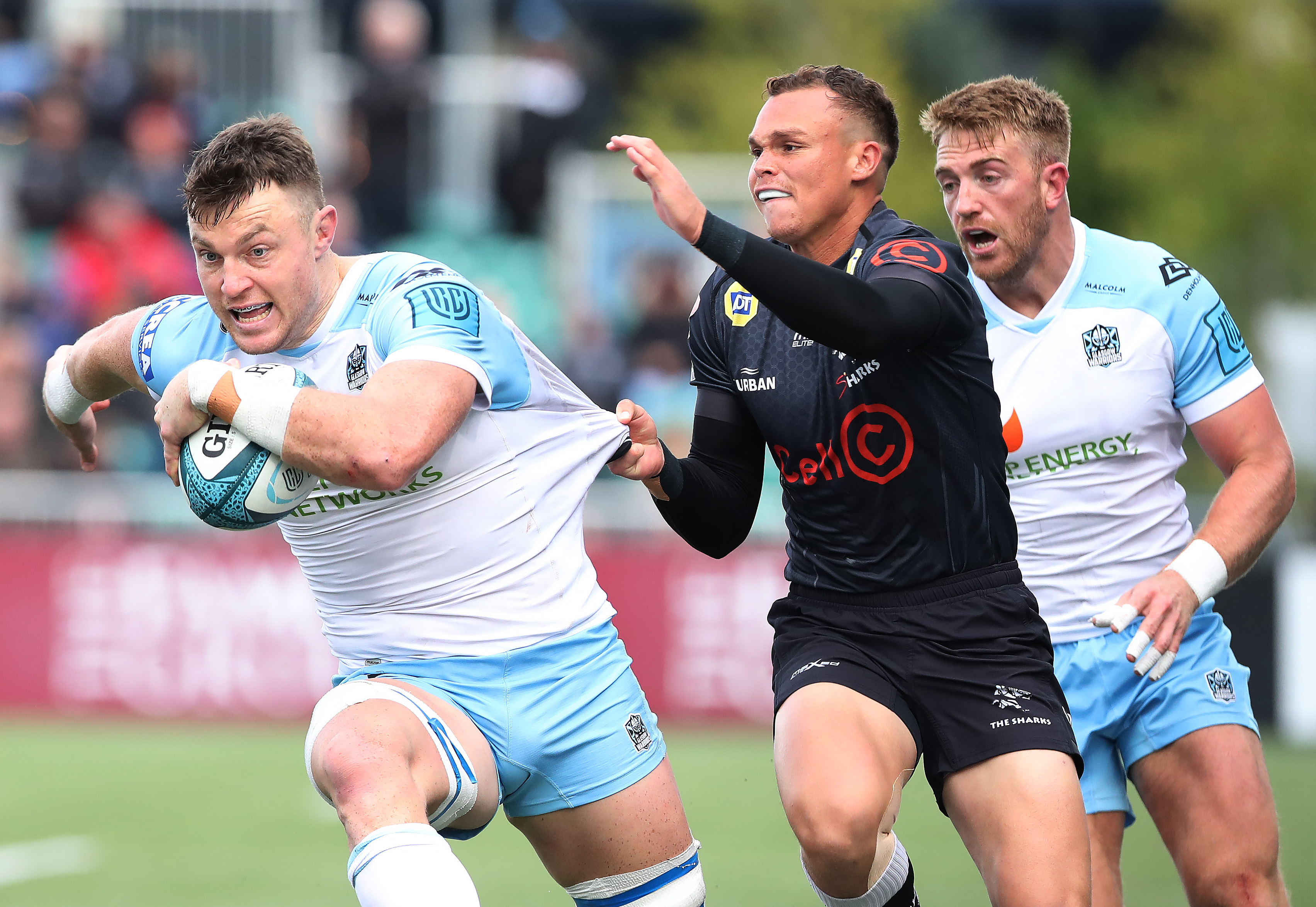 Jack Dempsey of the Glasgow Warriors is tackled by Curwin Bosch of the Sharks.