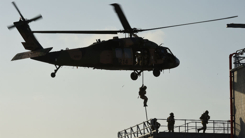 ADF soldiers rappel from a Blackhawk helicopter during a training exercise in Brisbane. (AAP)