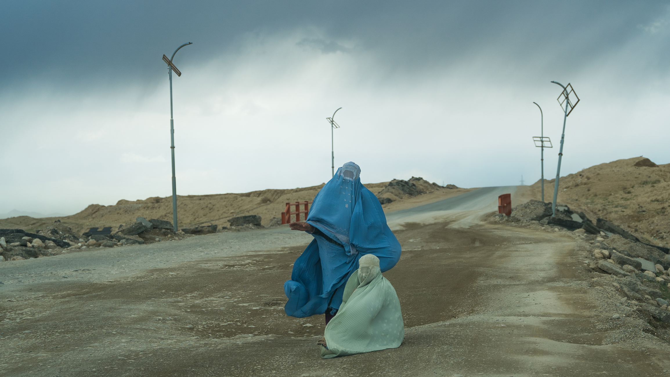 Kandahar - Ghazni highway, Afghanistan, 03.15.2025 women in traditional women's clothing, completely covering the body and face - burka (chador)