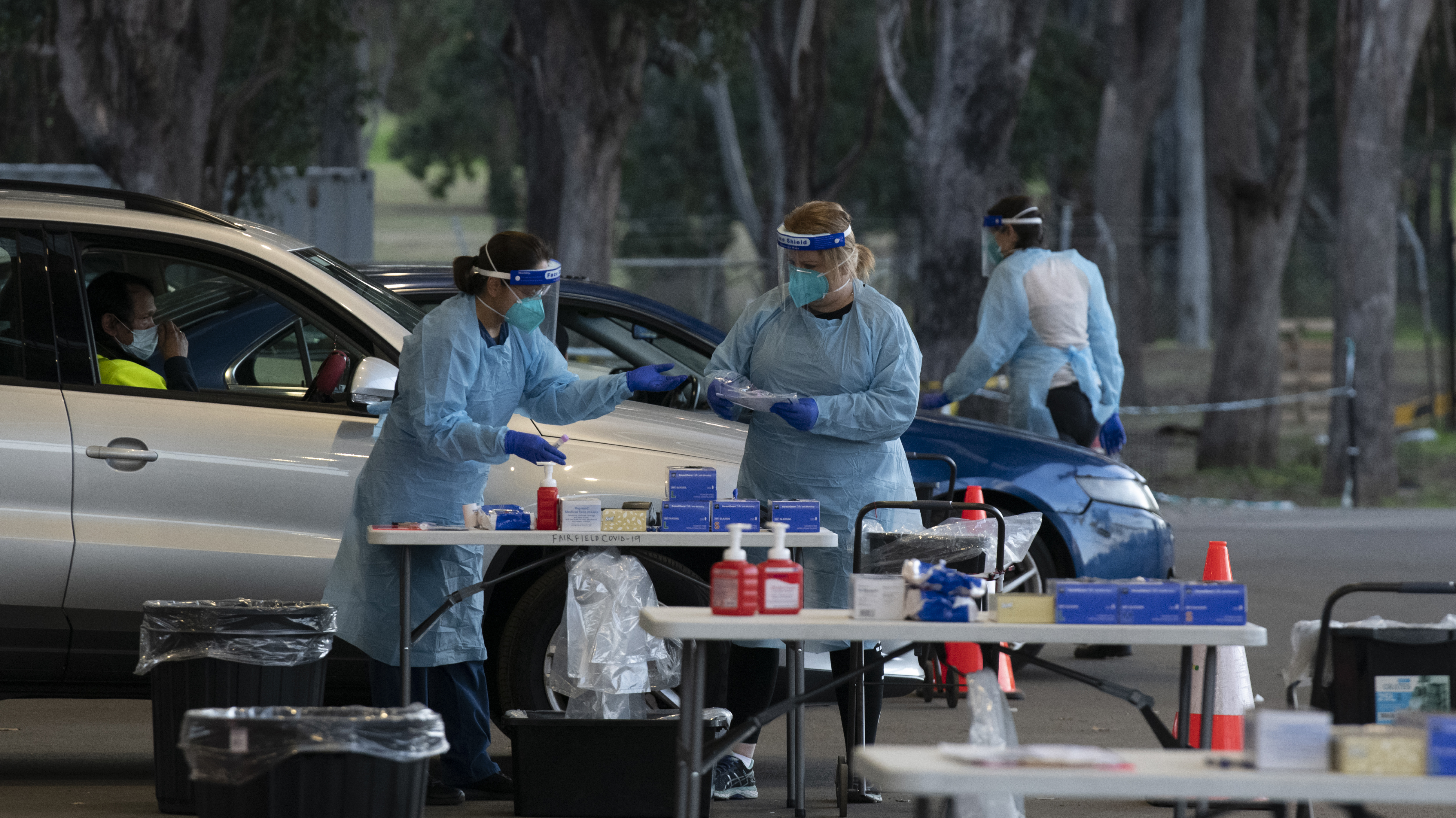 SydPath staff conduct COVID-19 tests at the 24 hour drive through clinic at Fairfield Showgrounds, Sydney.