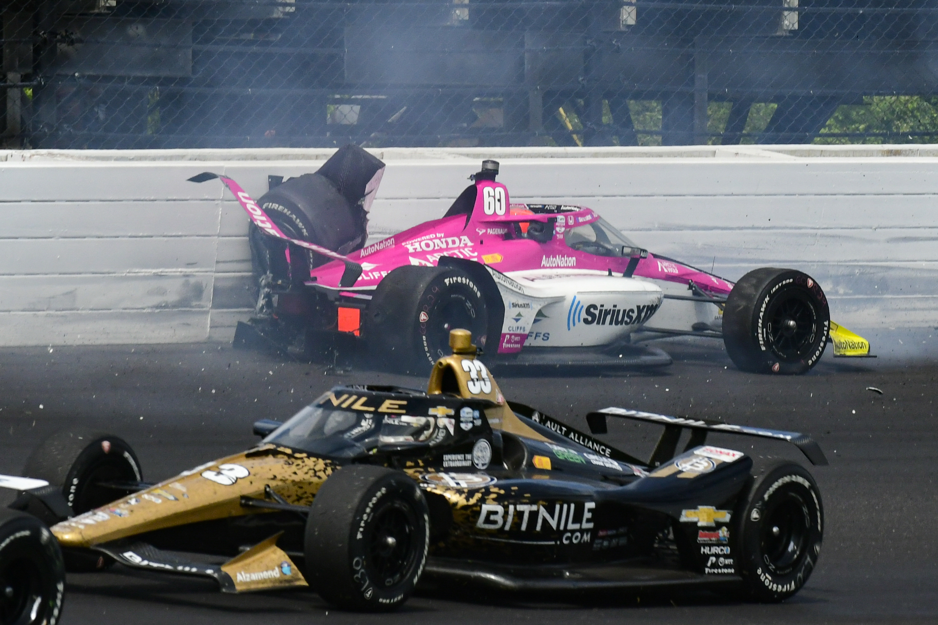 Simon Pagenaud hits the wall in the third turn during the Indianapolis 500 after contact with Scott McLaughlin.
