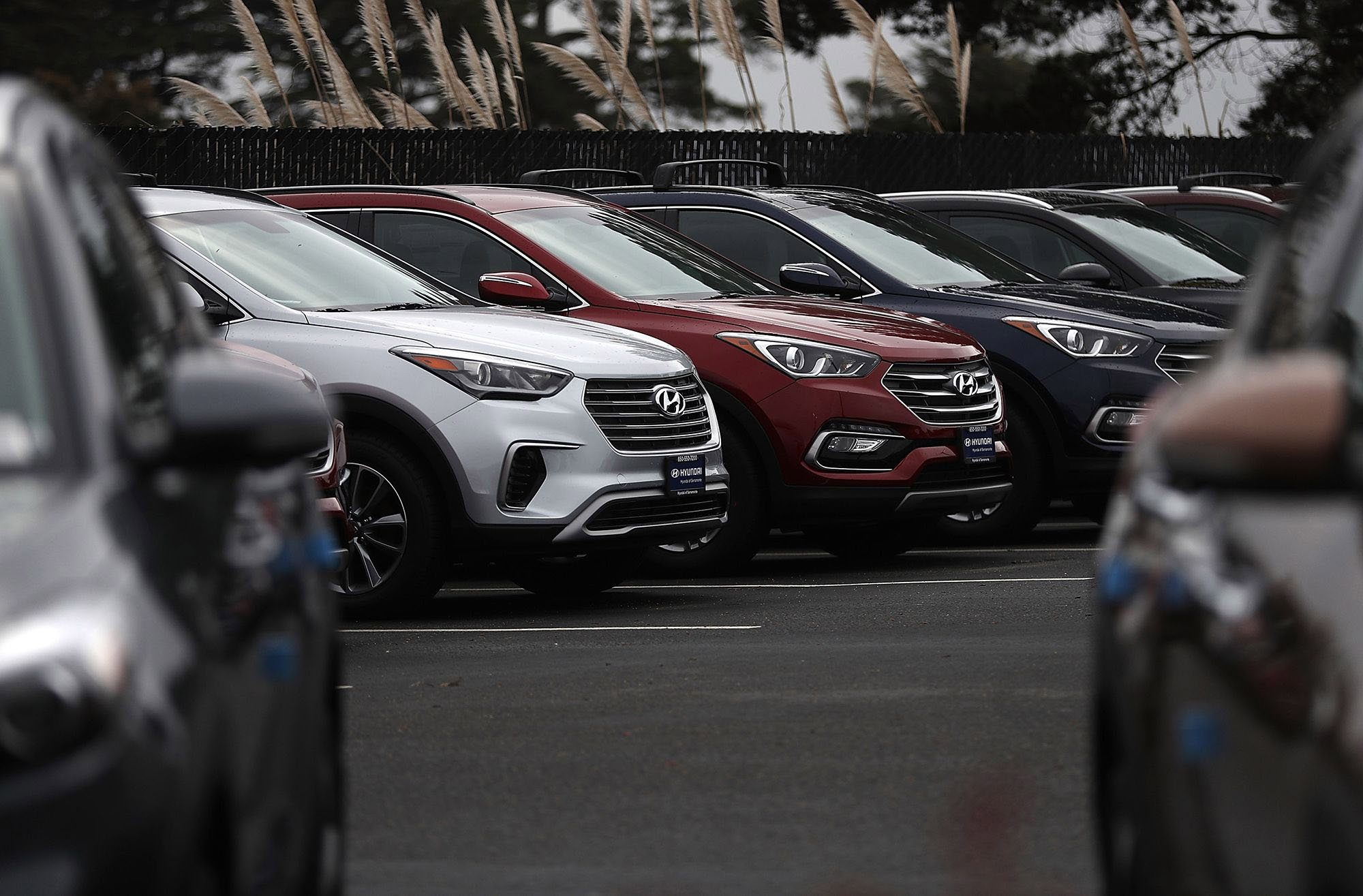 Brand new Hyundai Santa Fe SUVs are displayed at a Hyundai dealership