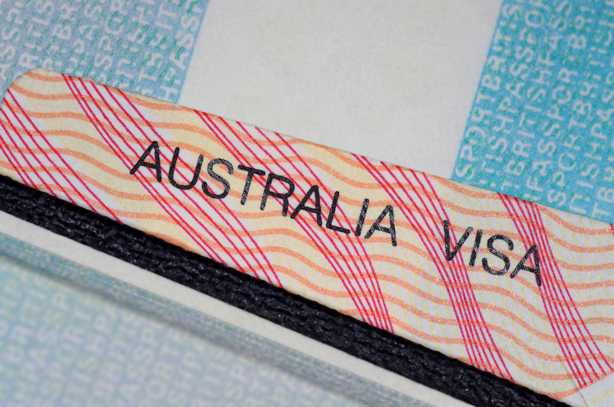 australian visa in between two british passport pages