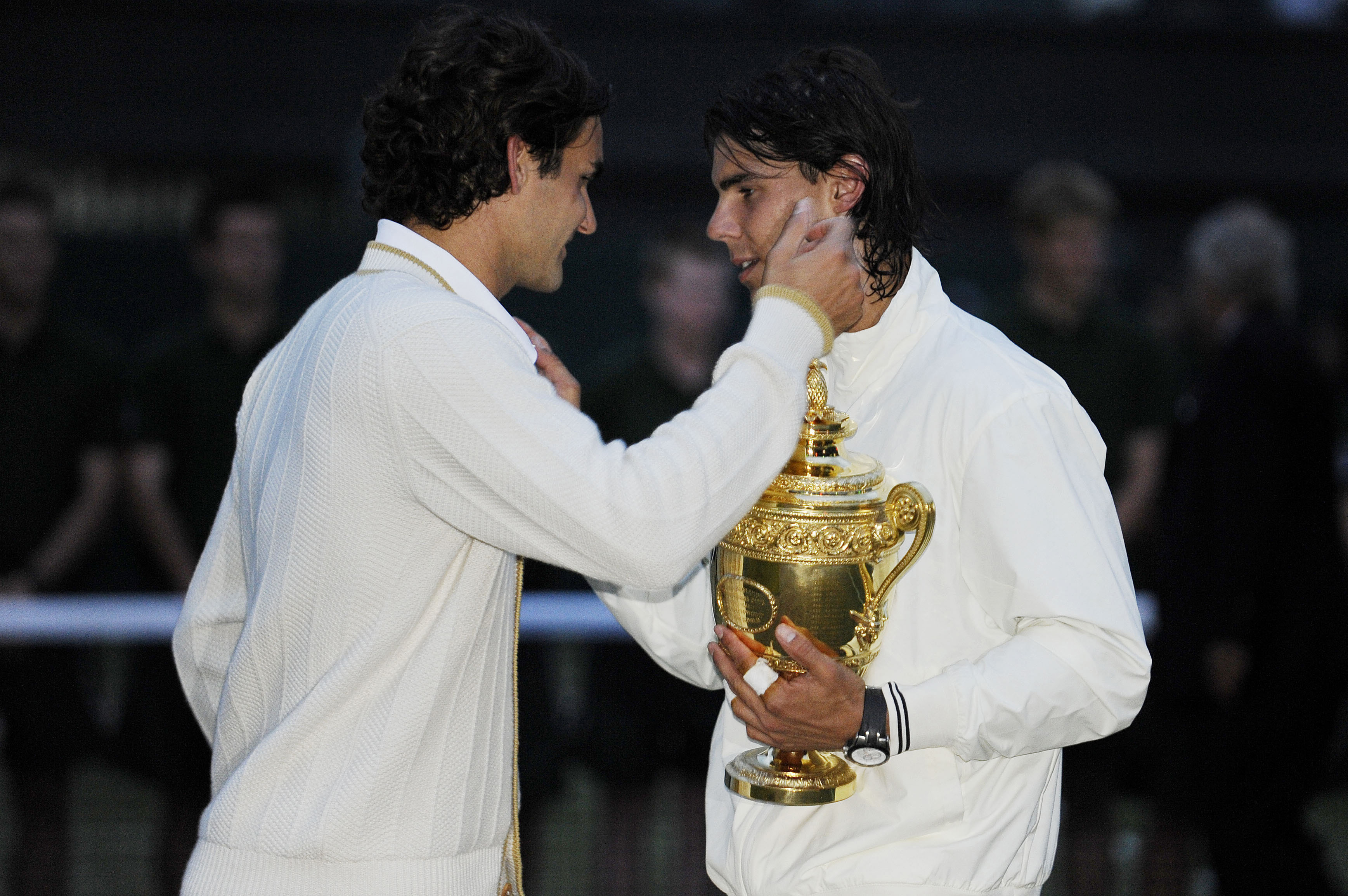 Rafael Nadal holds the trophy and is congratulated by Roger Federer after the men's singles final during day thirteen of the 2008 Wimbledon tennis championships at the All England Lawn Tennis Club on July 6th 2008 in Wimbledon (Photo by Tom Jenkins/Getty Images)