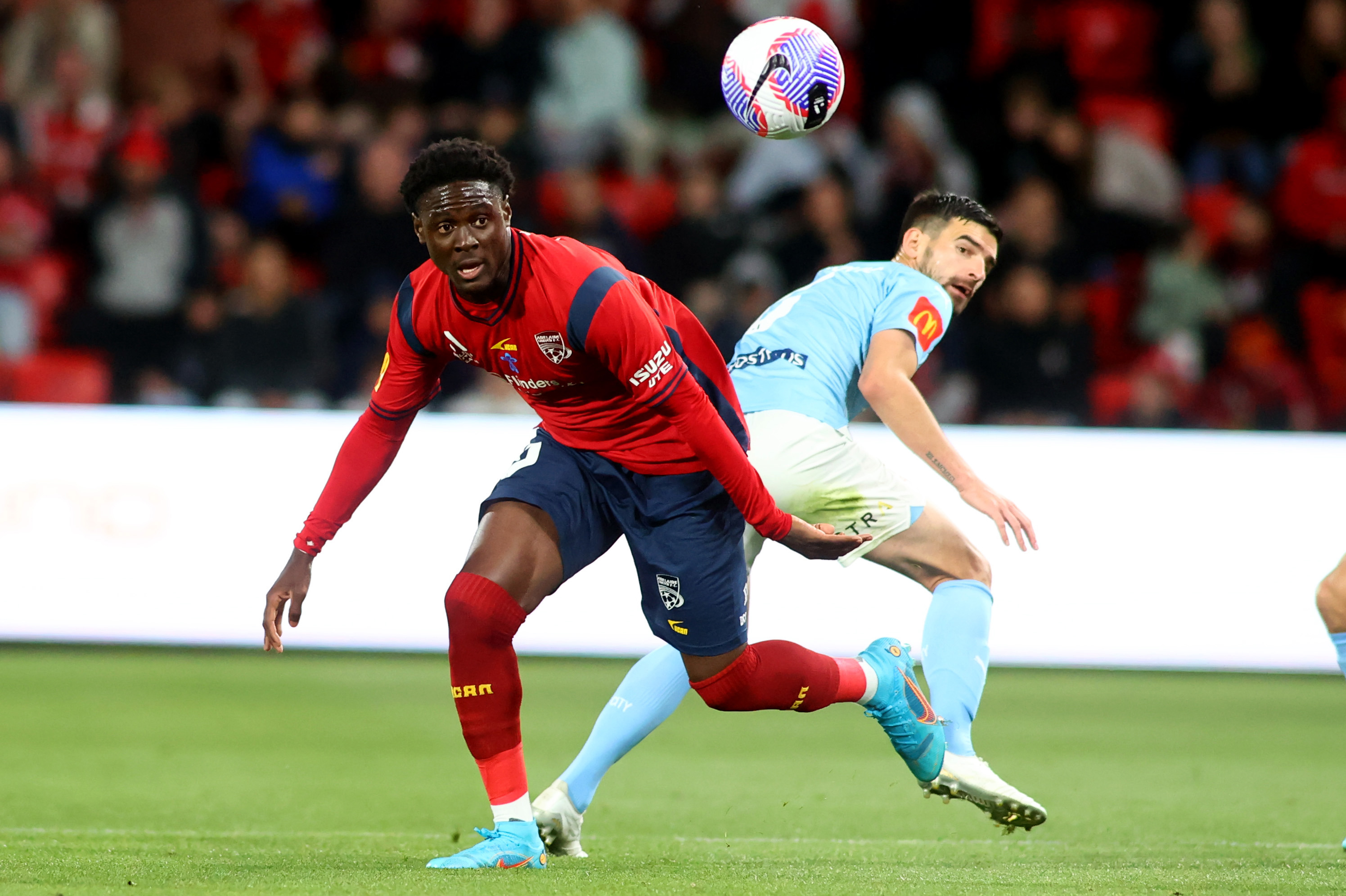 Musa Toure of United goes for the ball.