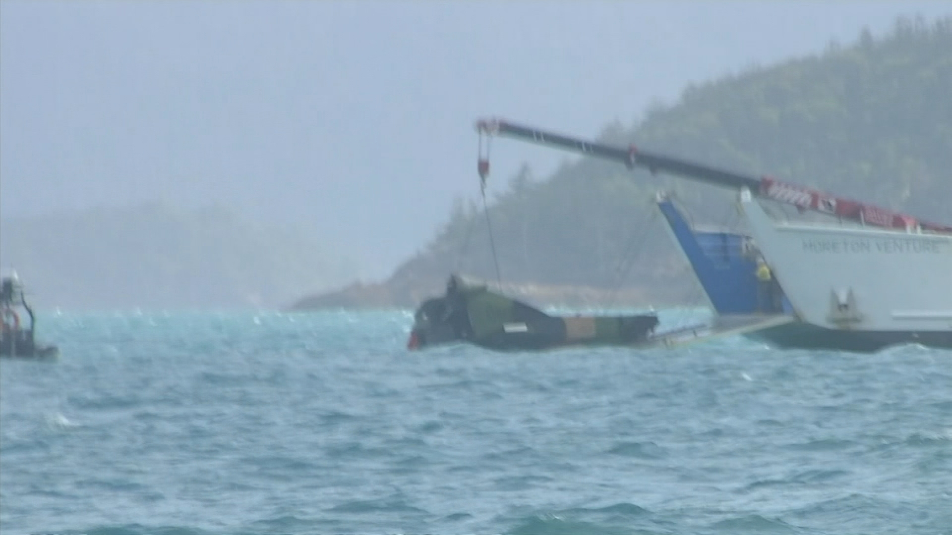 The wreckage of what is believed to an MRH-90 Taipan in Whitsunday waters. Search and rescue crews have found debris in the search for four Australian defence helicopter crew who are feared dead after their aircraft went down off Hamilton Island in Queensland late last night.